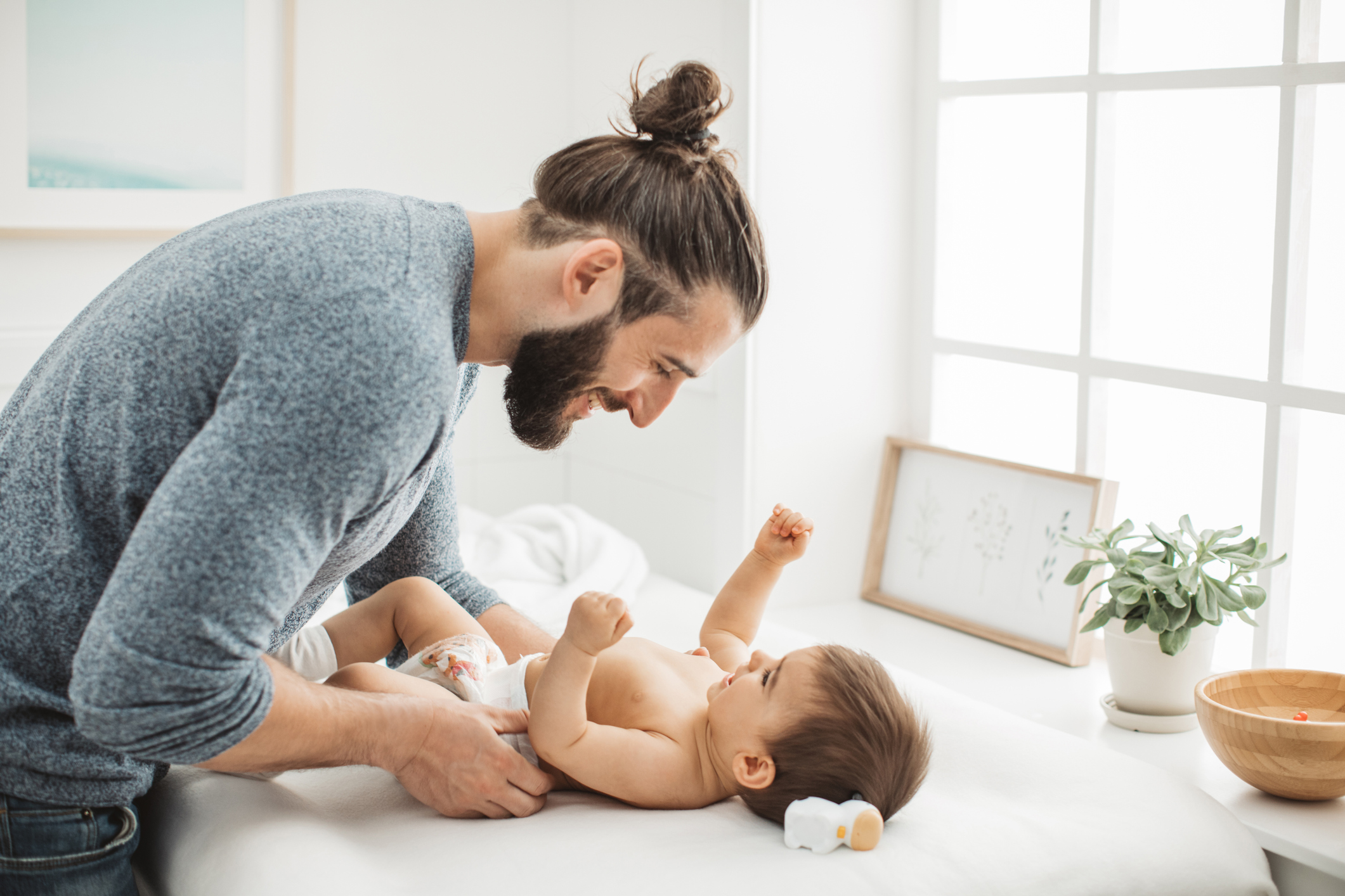 A person changes a baby's diaper.