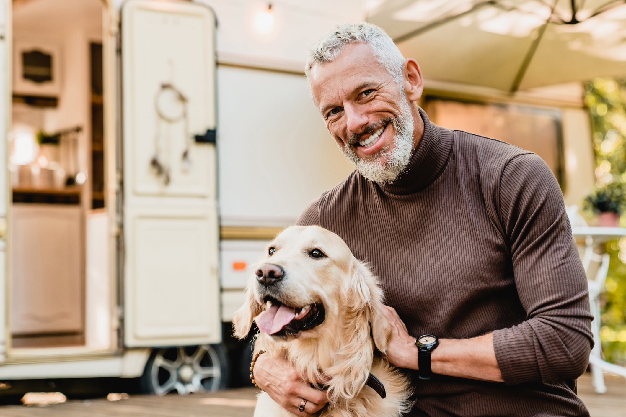A smiling person holding a dog.