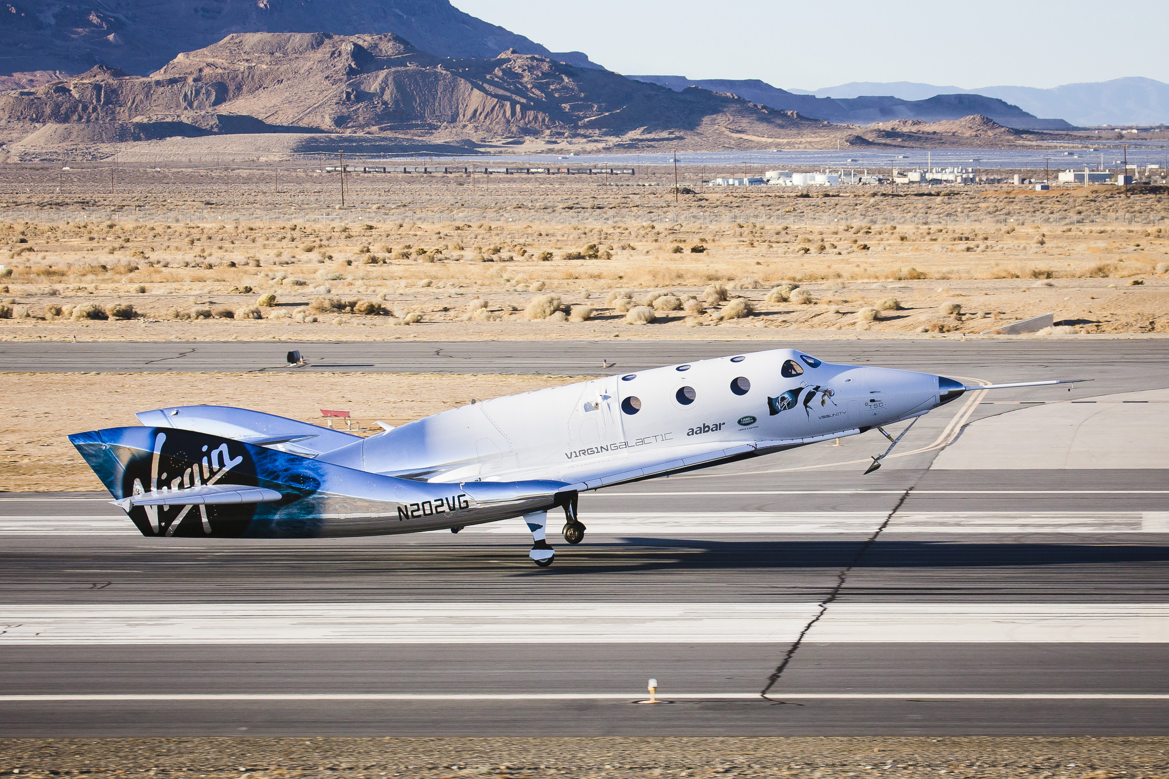 Virgin Galactic spacecraft touching down on runway.