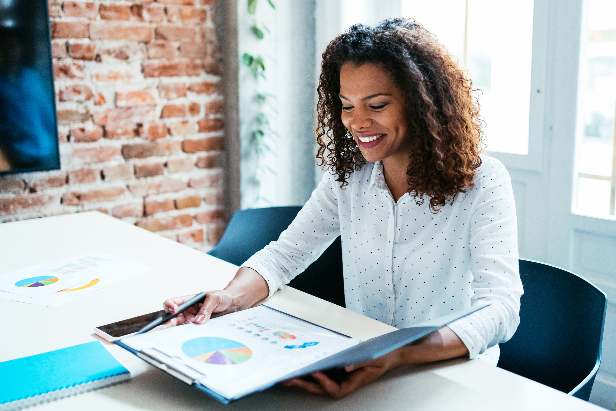 A person looking at charts in a binder.