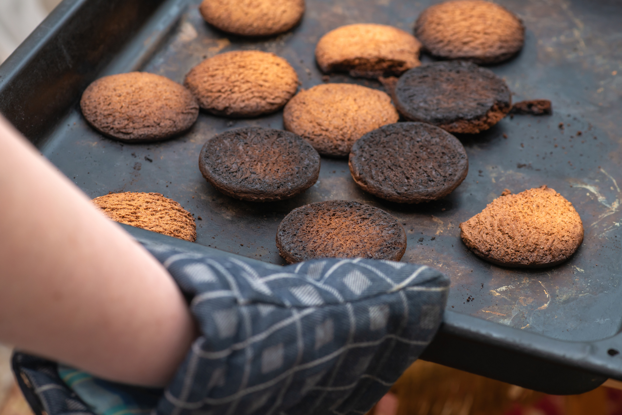 Pulling burned cookies out of the oven. 