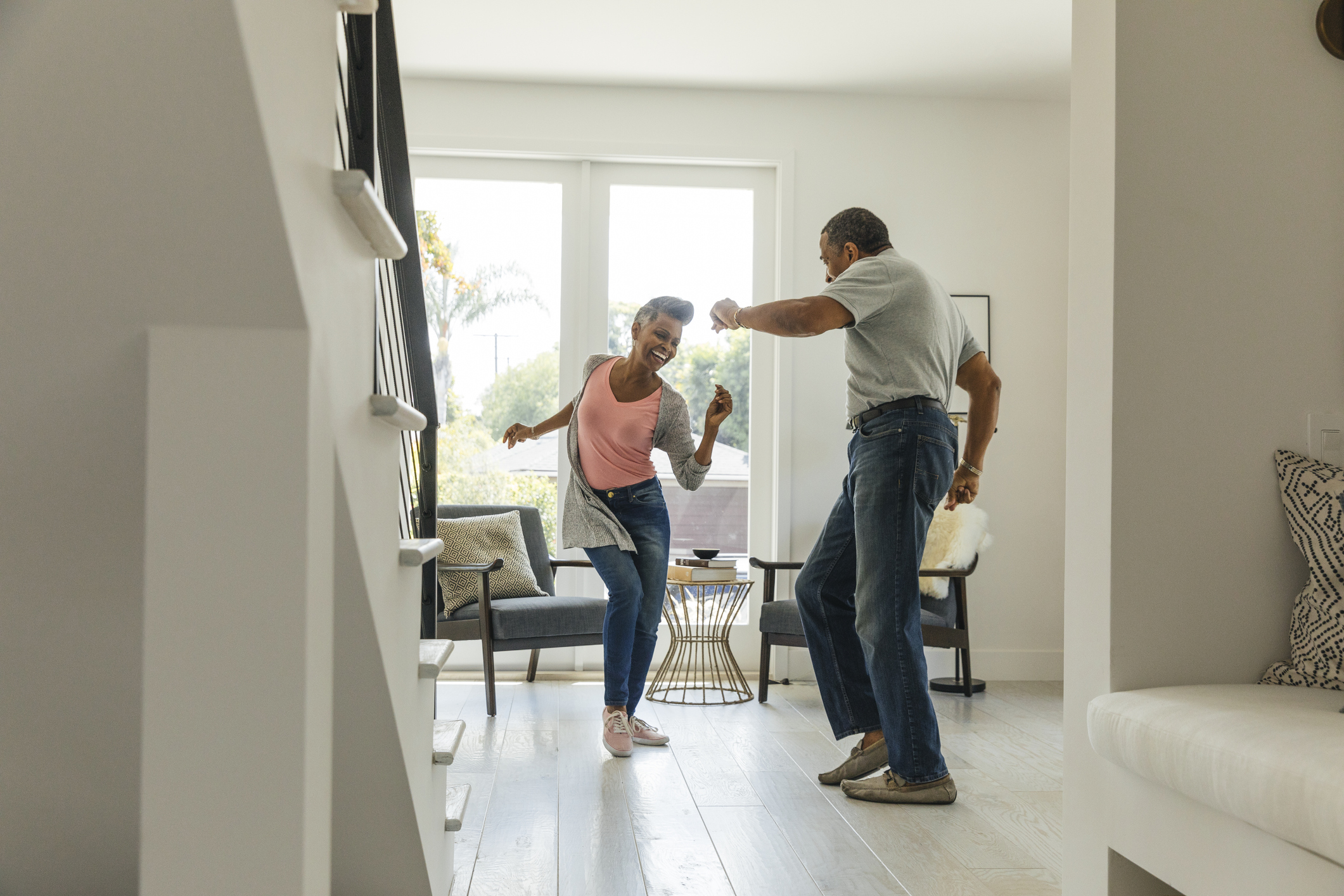 Couple dancing in their living room.