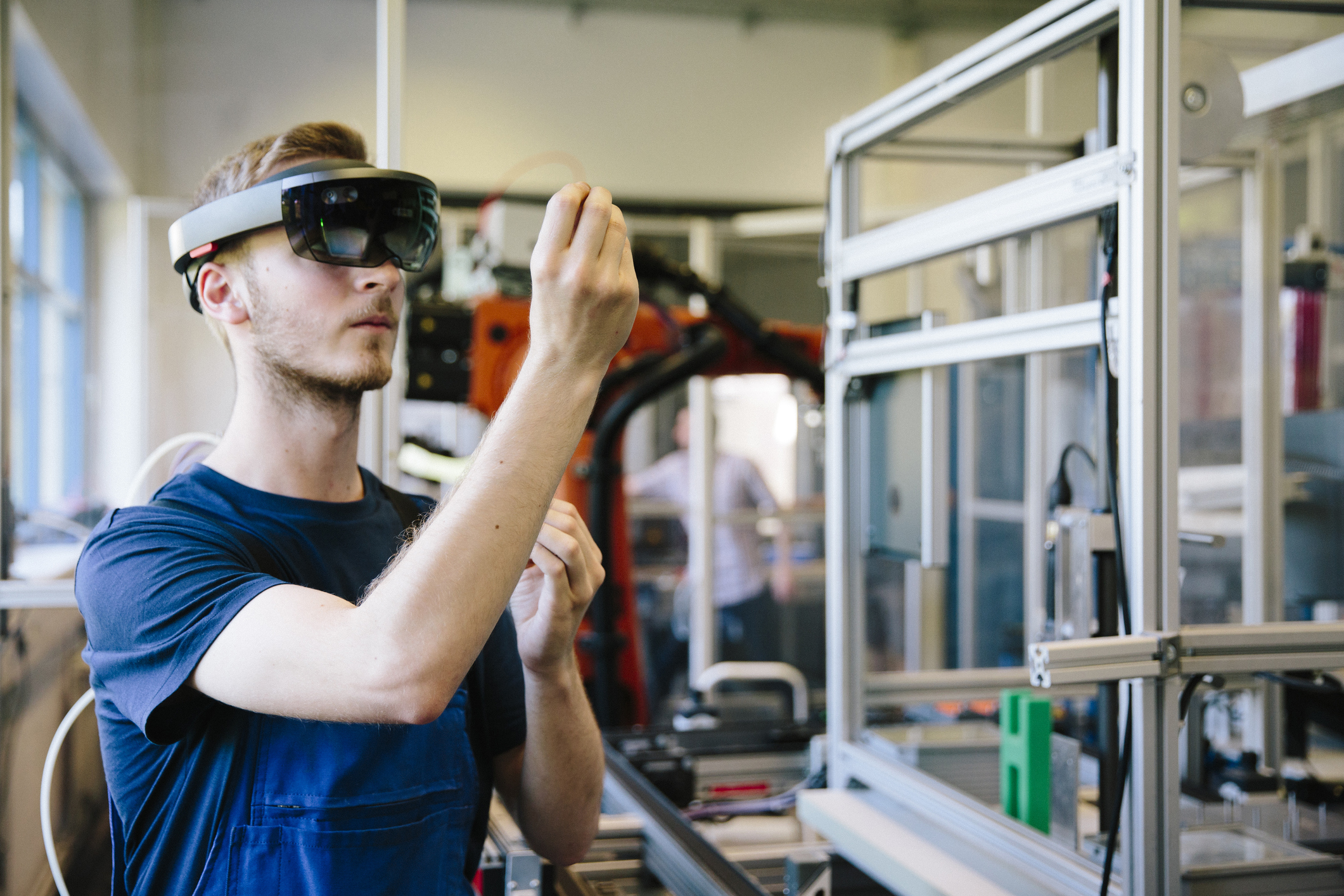 An industrial designer using a holographic device at work.