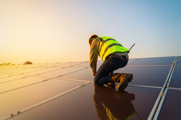 A person installing solar panels.