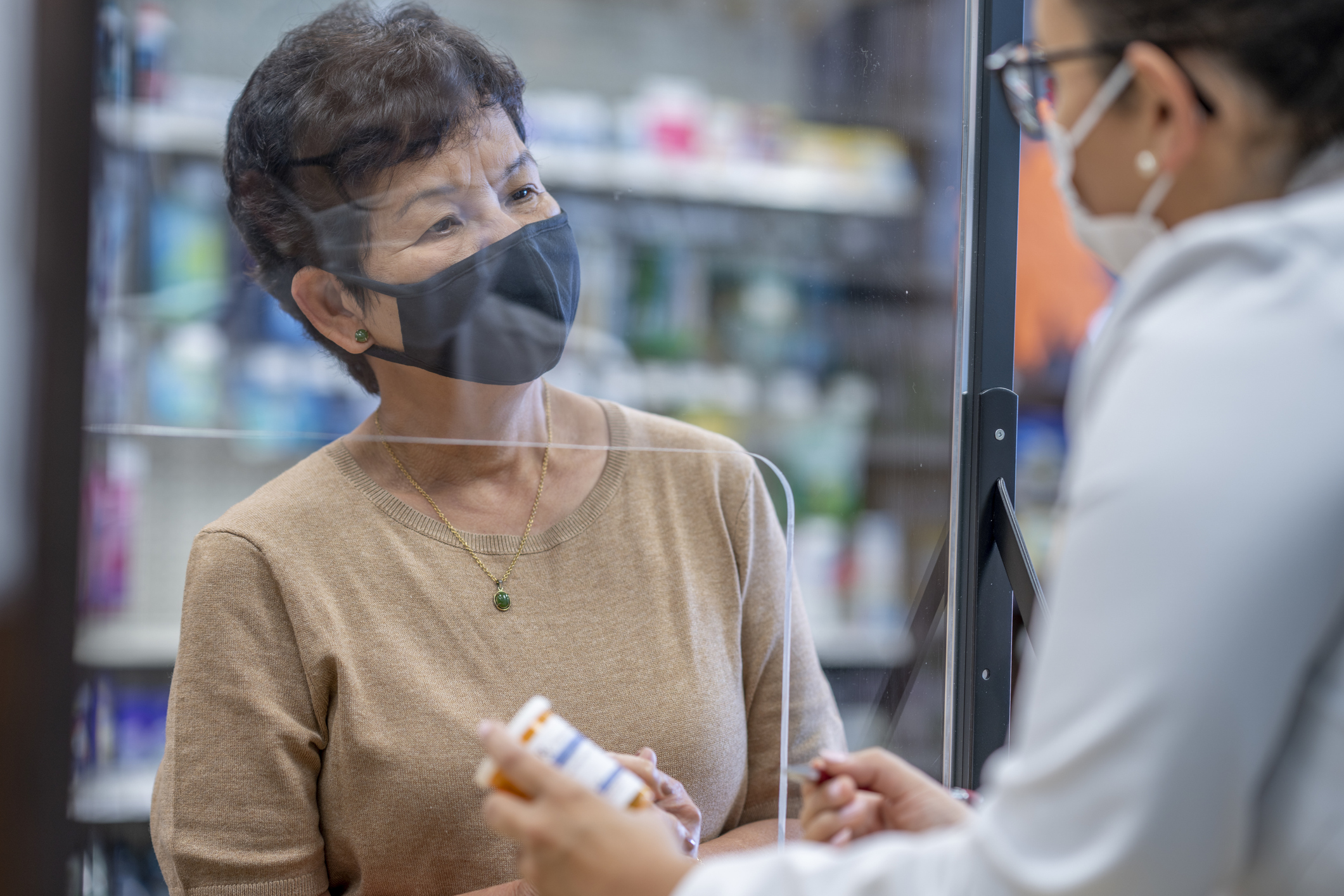 A person speaks with their pharmacist.