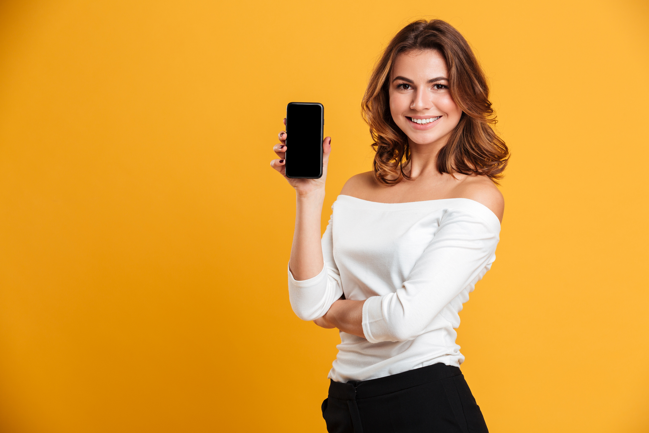 A person holding up a mobile phone.