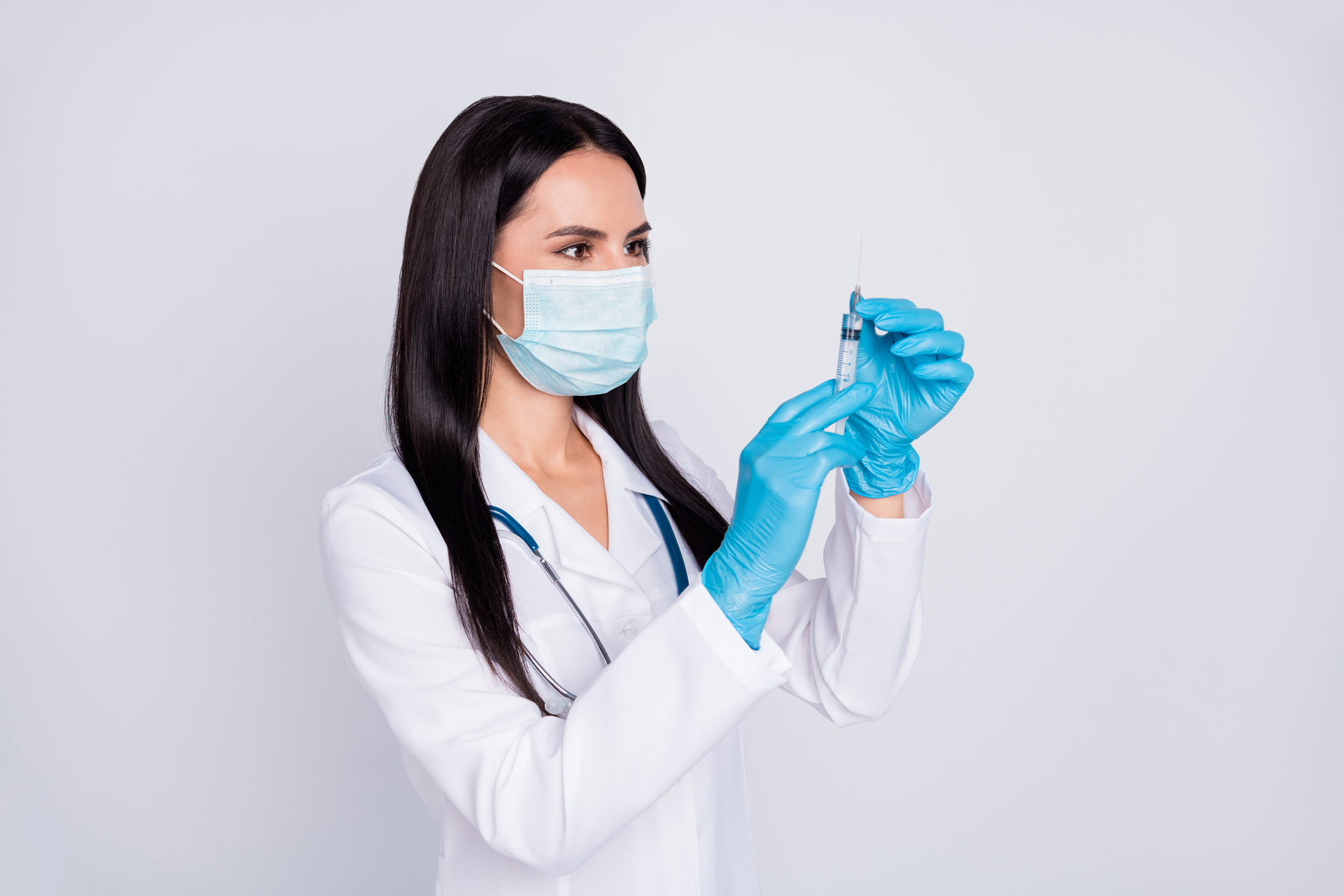 A medical worker with a syringe.