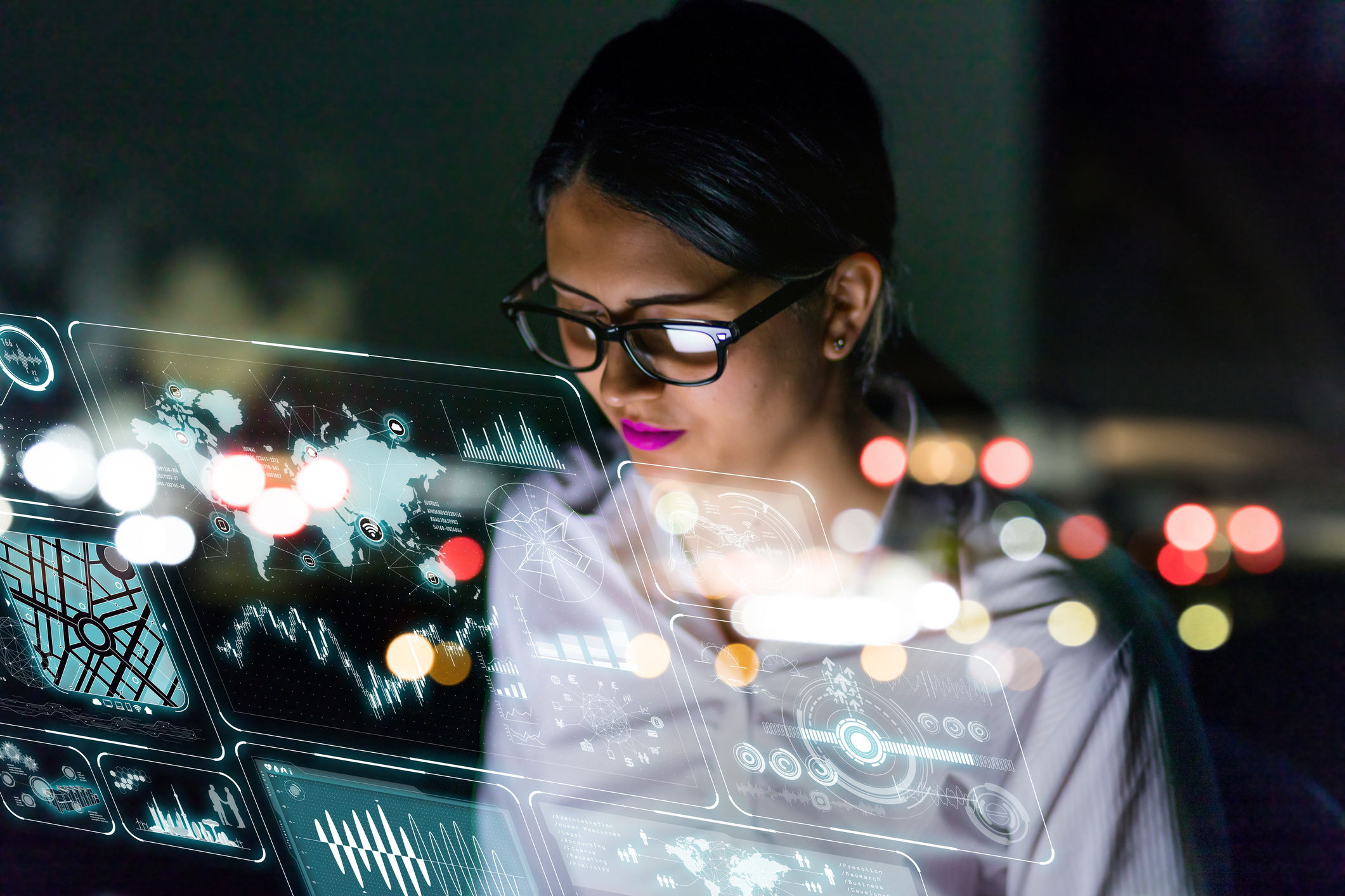 Person looking at virtual screen with various graphs and graphics.