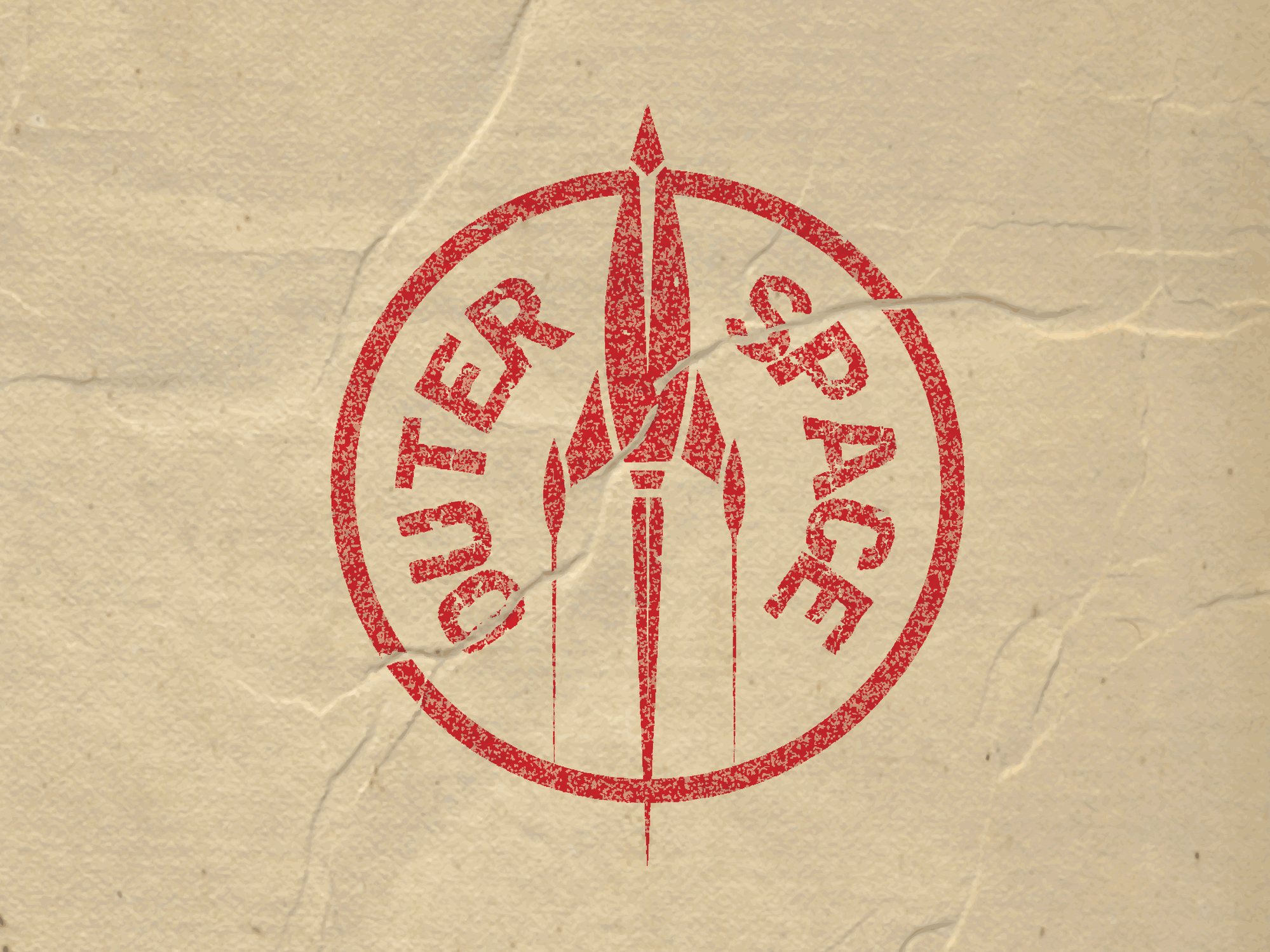 A red stamp that says "outer space" printed on cardboard.