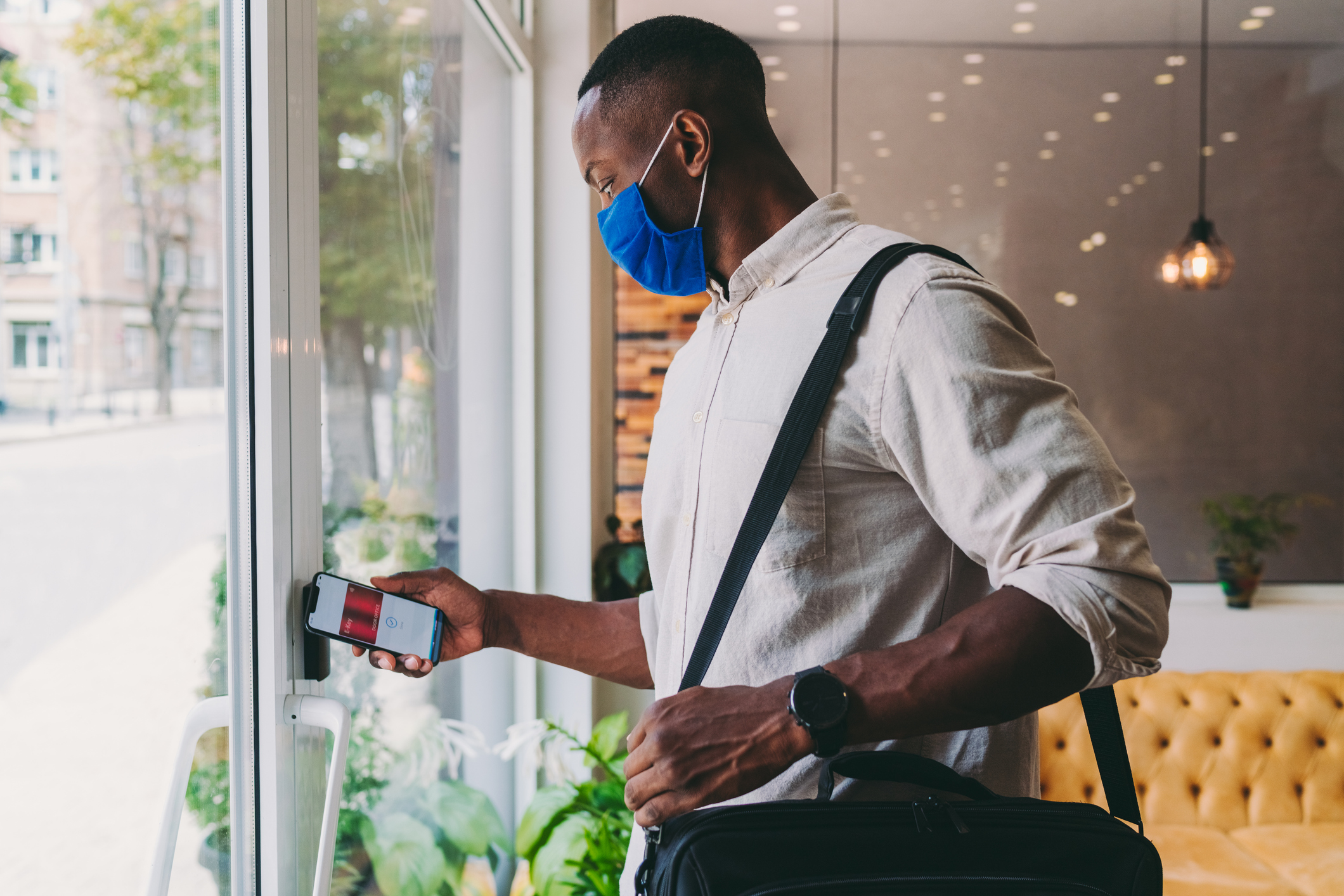 A person unlocking a door with a mobile device.