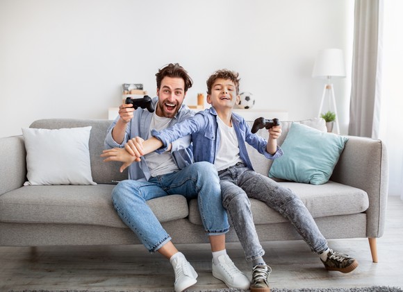 Adult playing video games with a child.