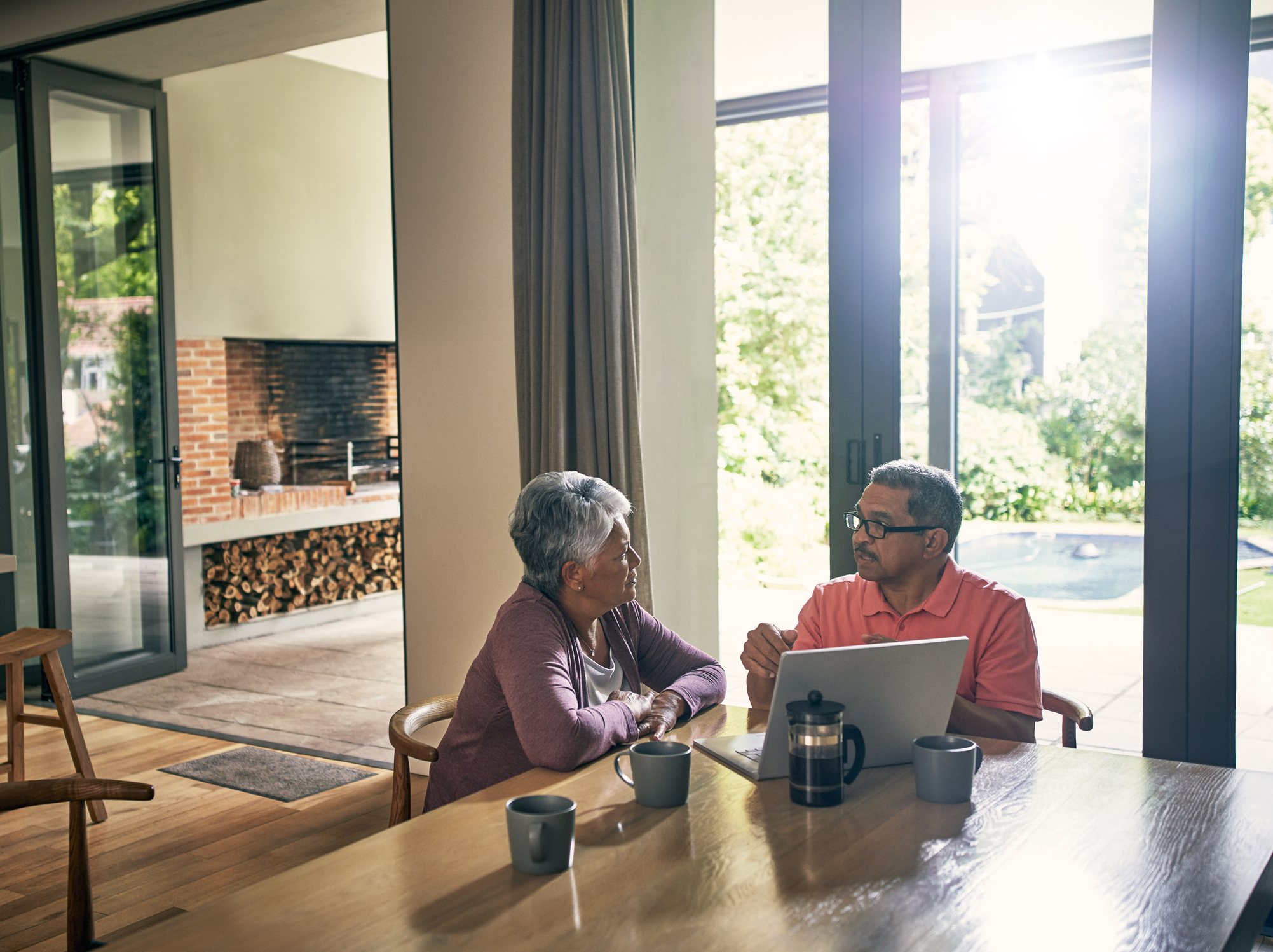 Two people at a table with a laptop open.