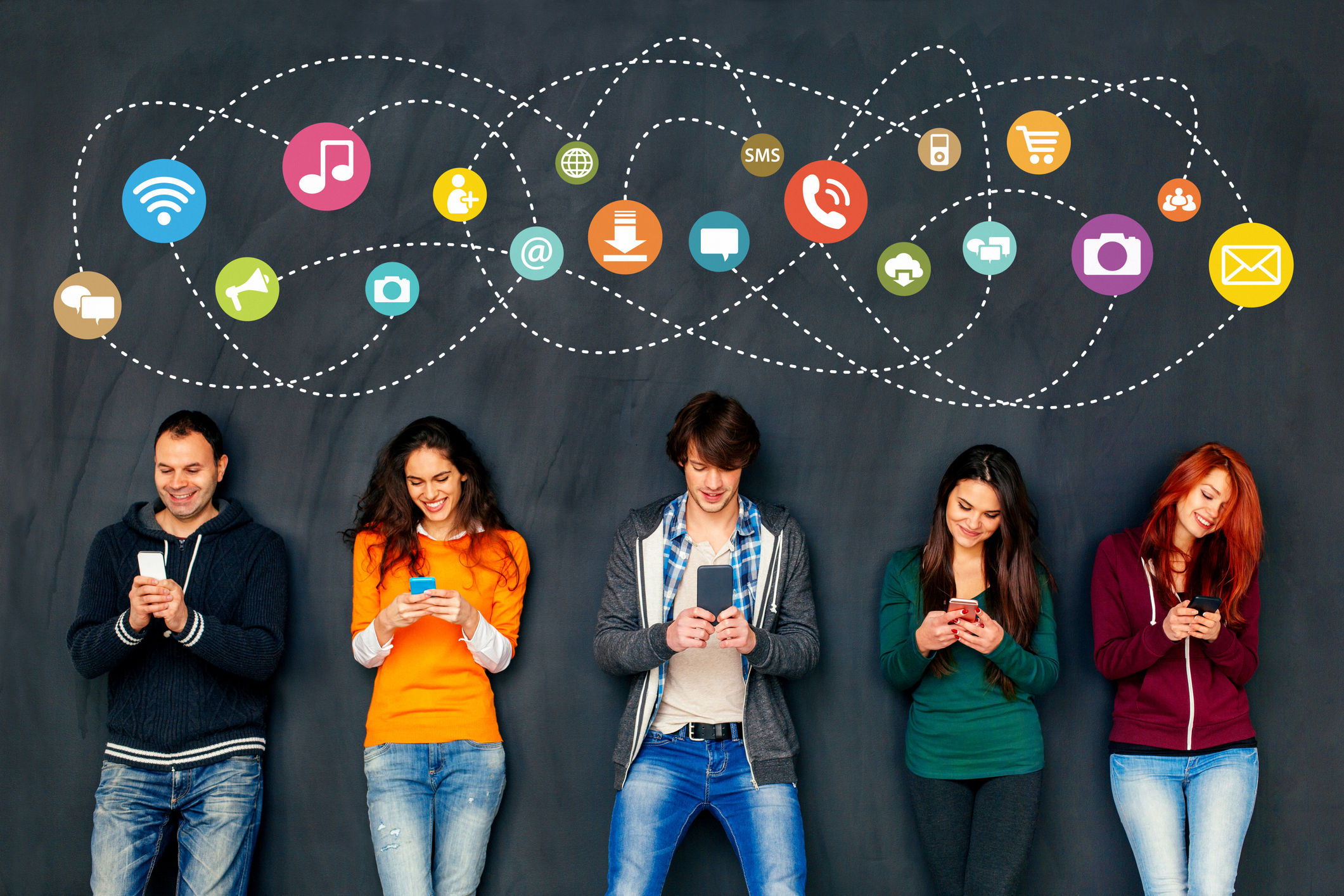 Group of young adults engaged with their smartphones.