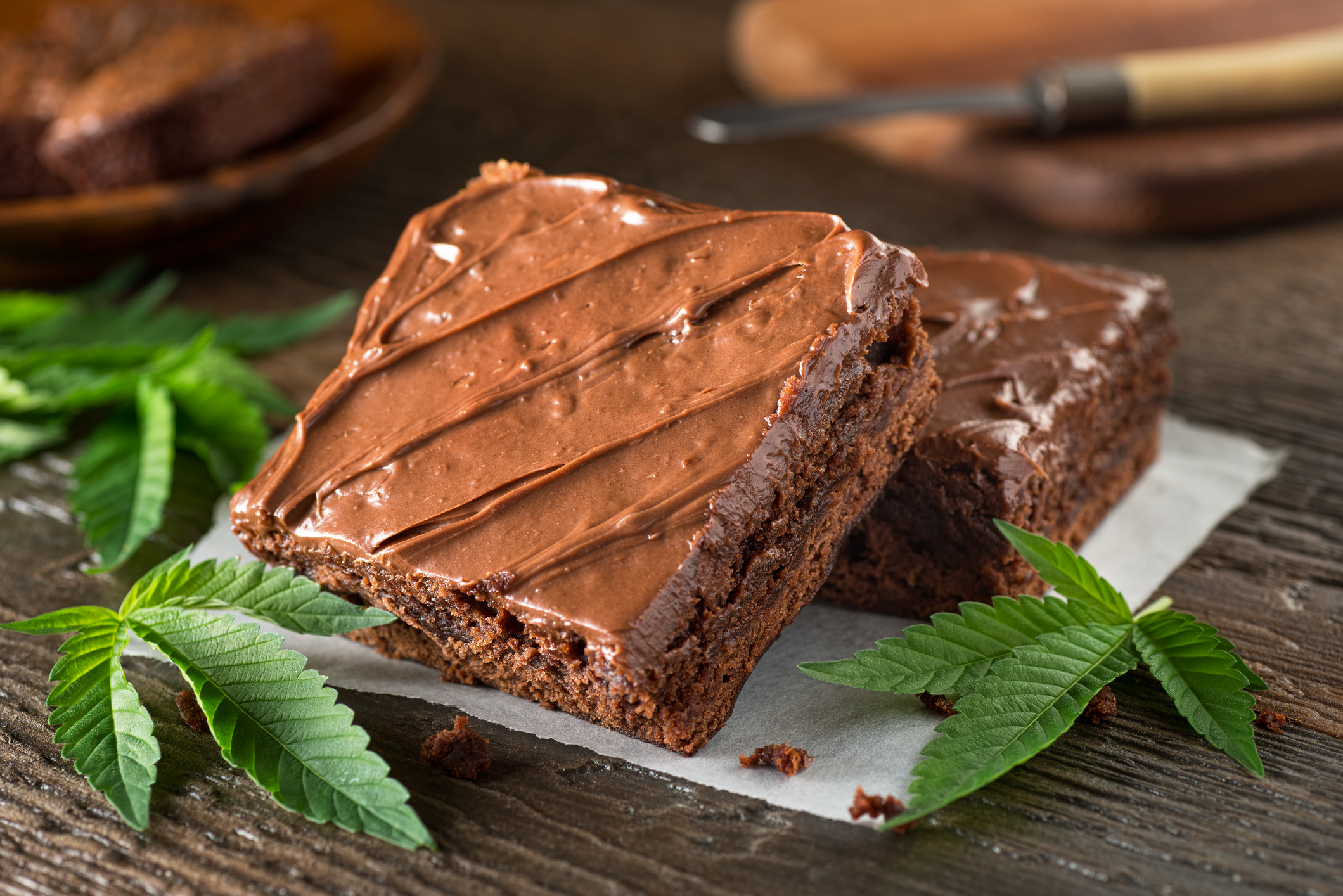 Chocolate brownies and cannabis leaves.