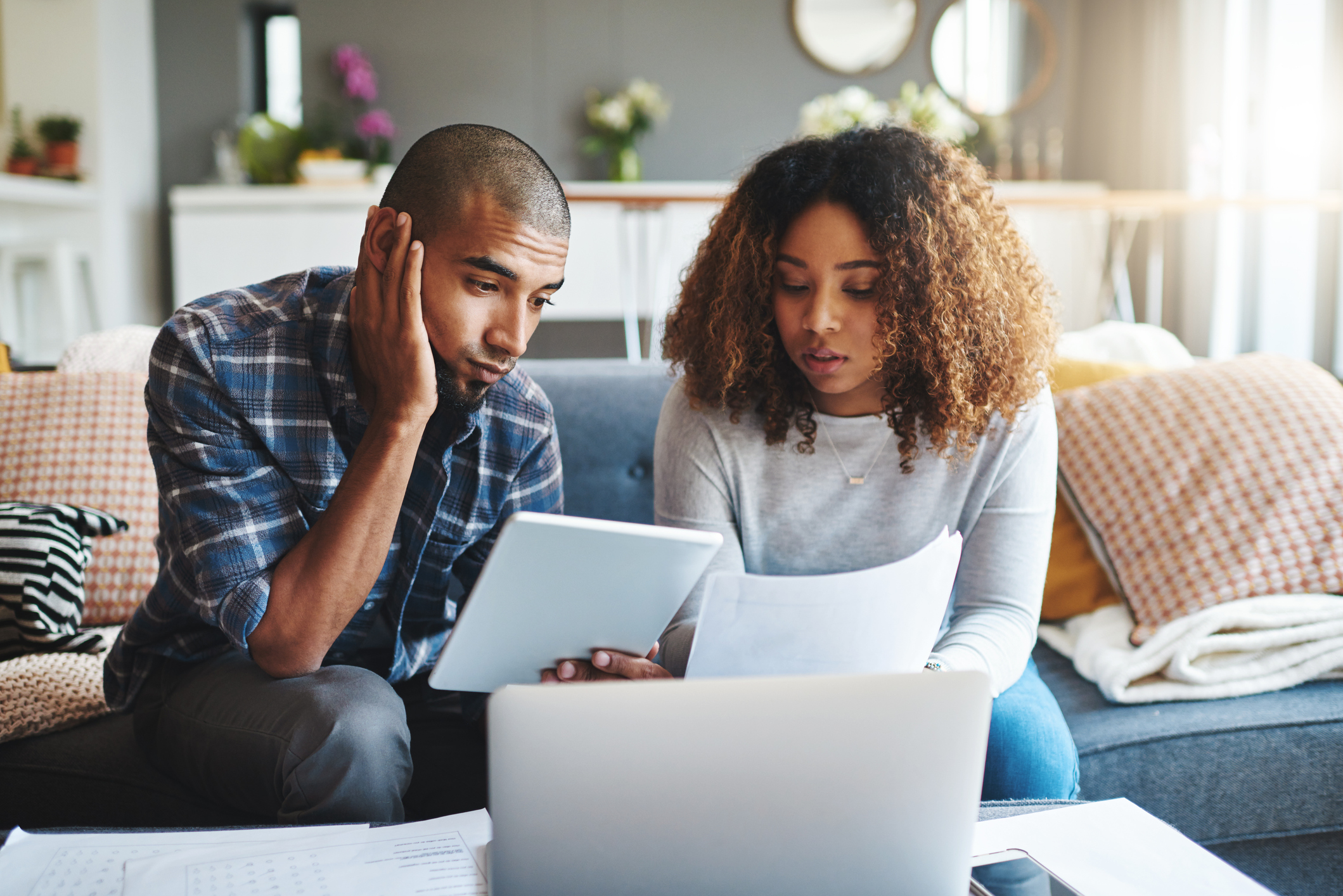 People looking at a laptop with concern.