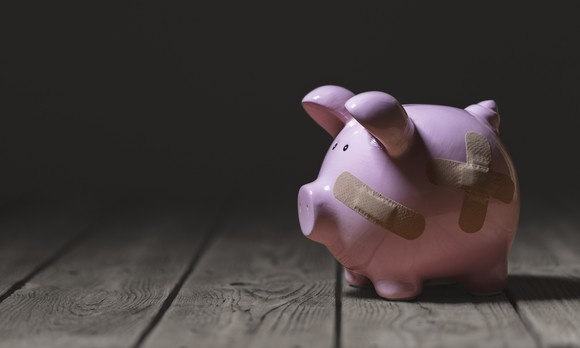 A piggybank with bandaids on it.