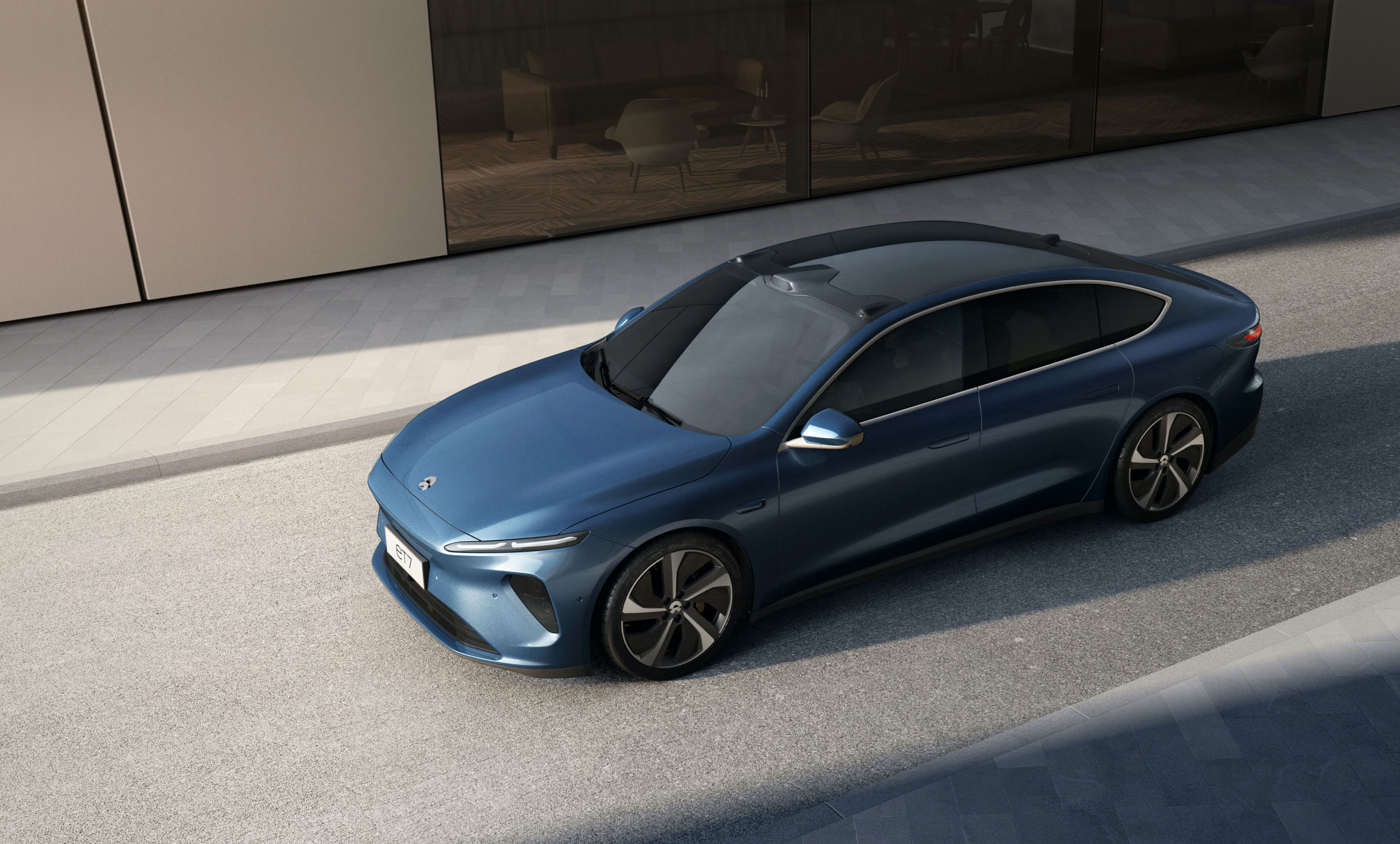 A blue Nio ET7, an electric luxury-sports sedan.