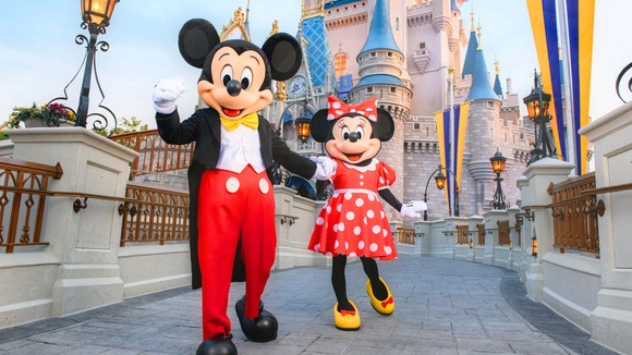 Mickey and Minnie in traditional duds in front of the castle.