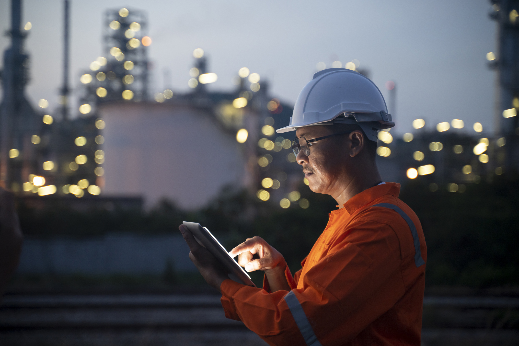 worker doing inspections at a refinery