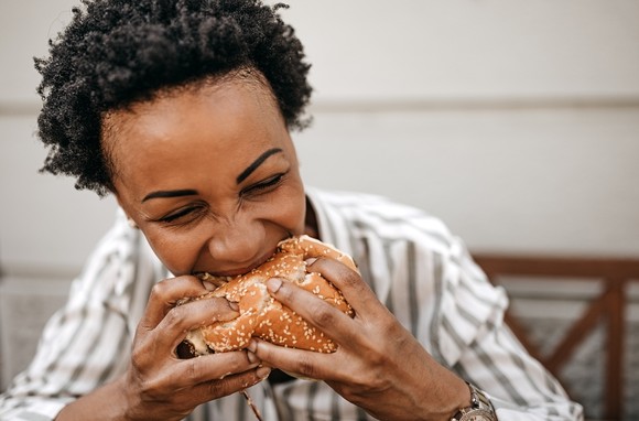 A person eating a hamburger.