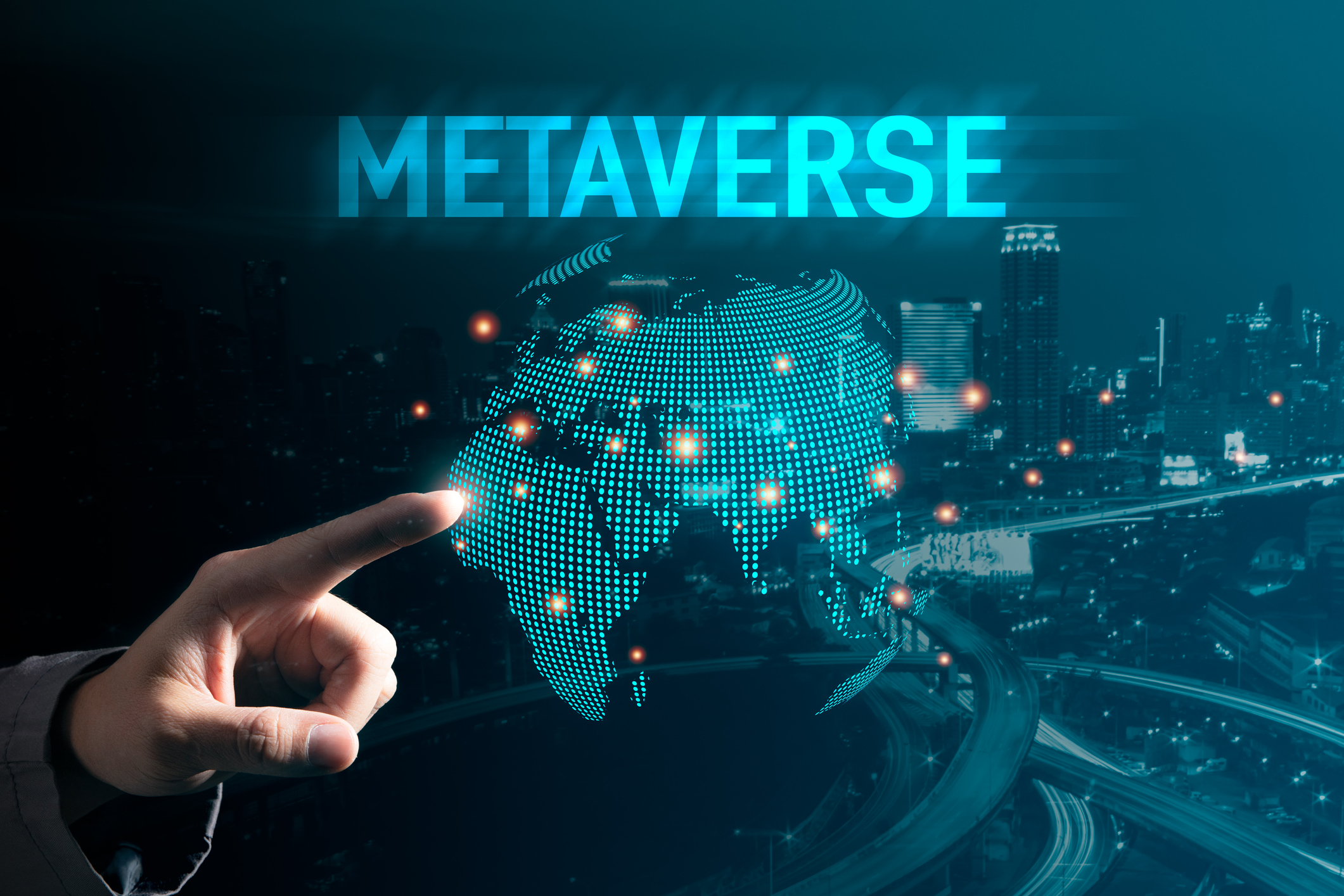 A person reaches out to touch a virtual map with the word metaverse hovering above it.