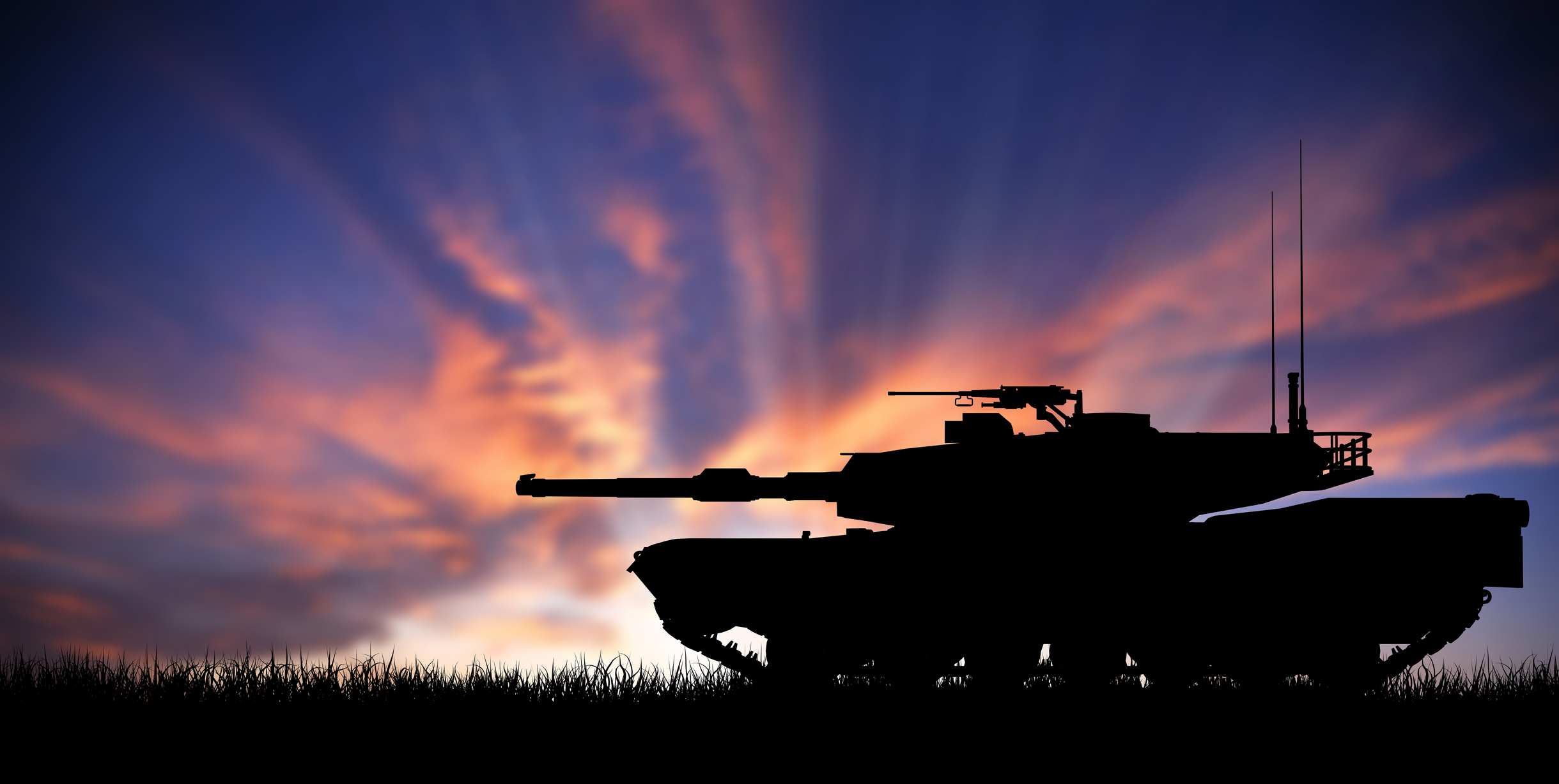 M1 Abrams Main Battle Tank silhouetted against a sunset.