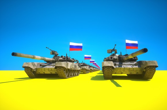 Column of tanks flying Russian flags rolling across a field of yellow and blue -- the Ukrainian national colors.