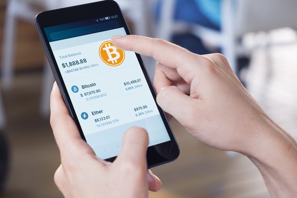 A person buys Bitcoin on their phone.