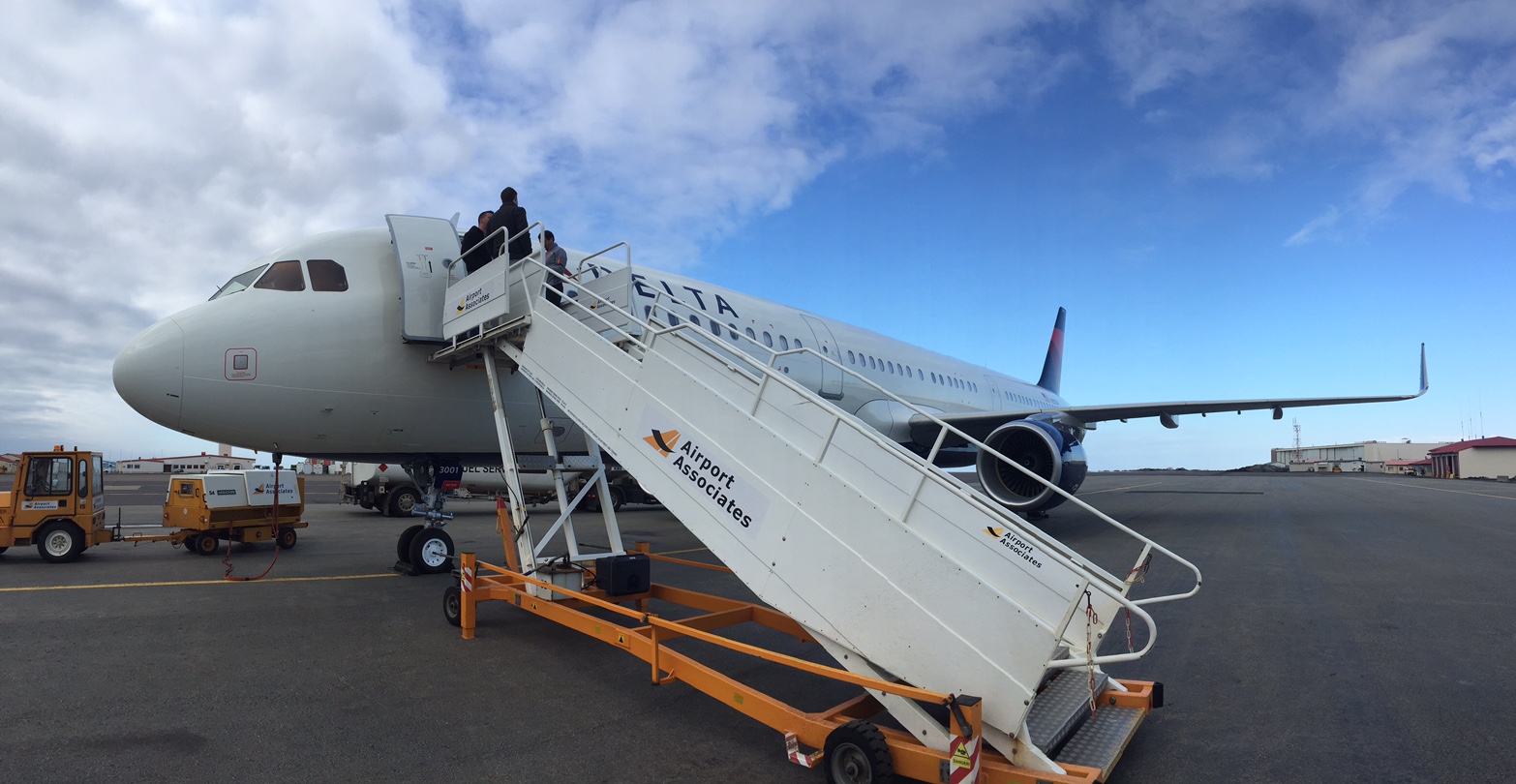 A Delta plane unloading passengers at an airport.