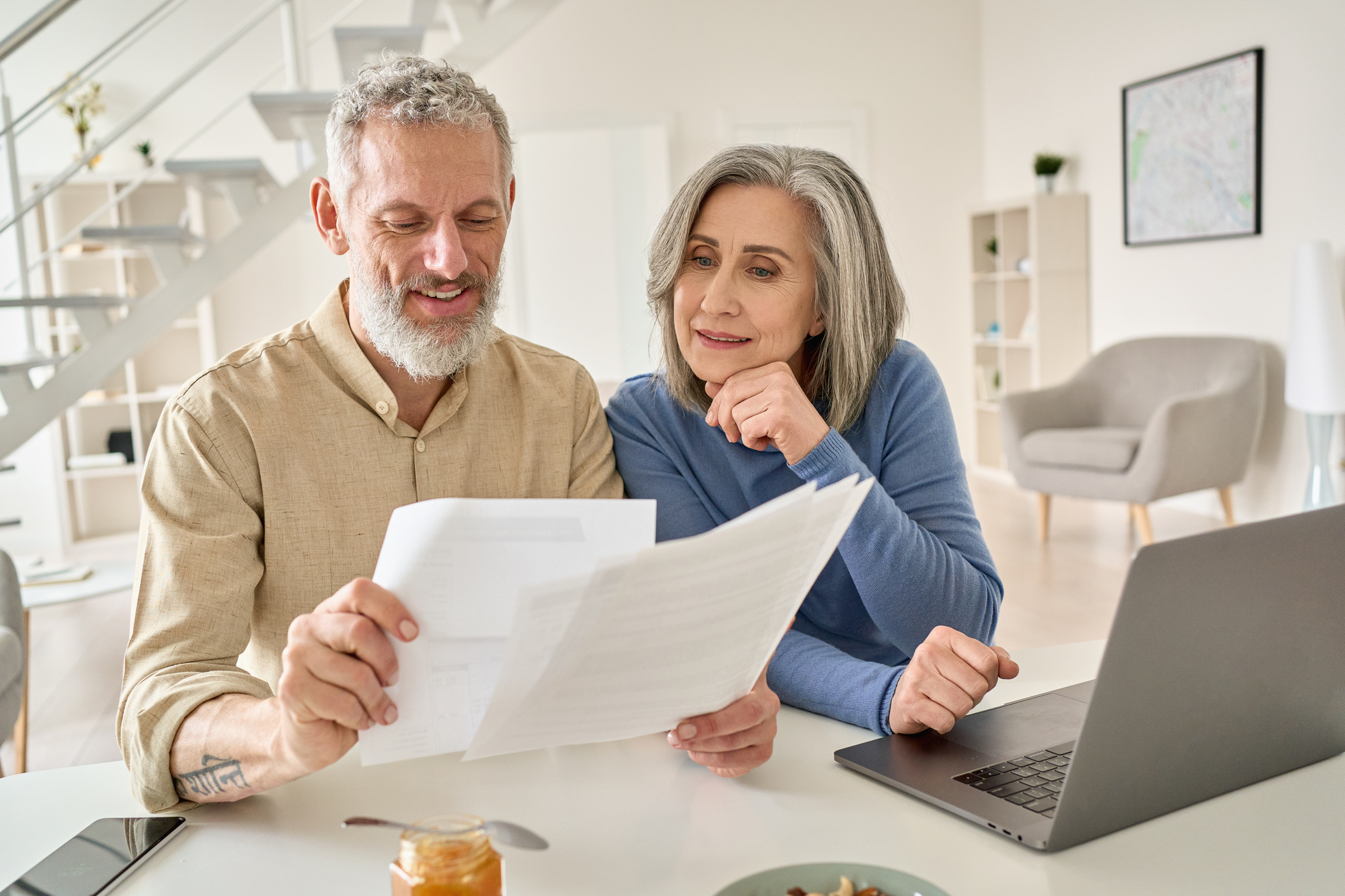 elderly couple looking at statements