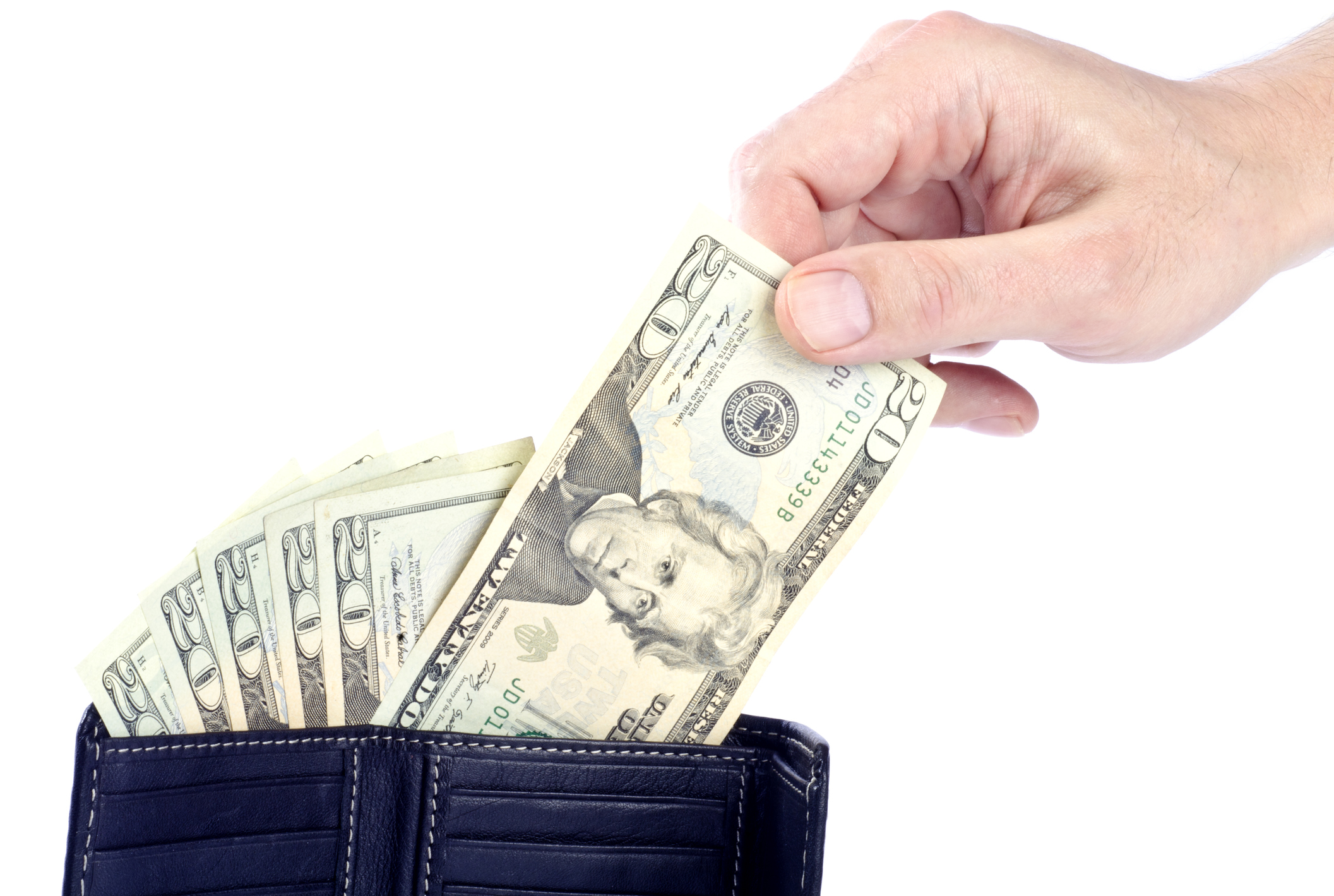 A person pulling $20 out of a wallet.