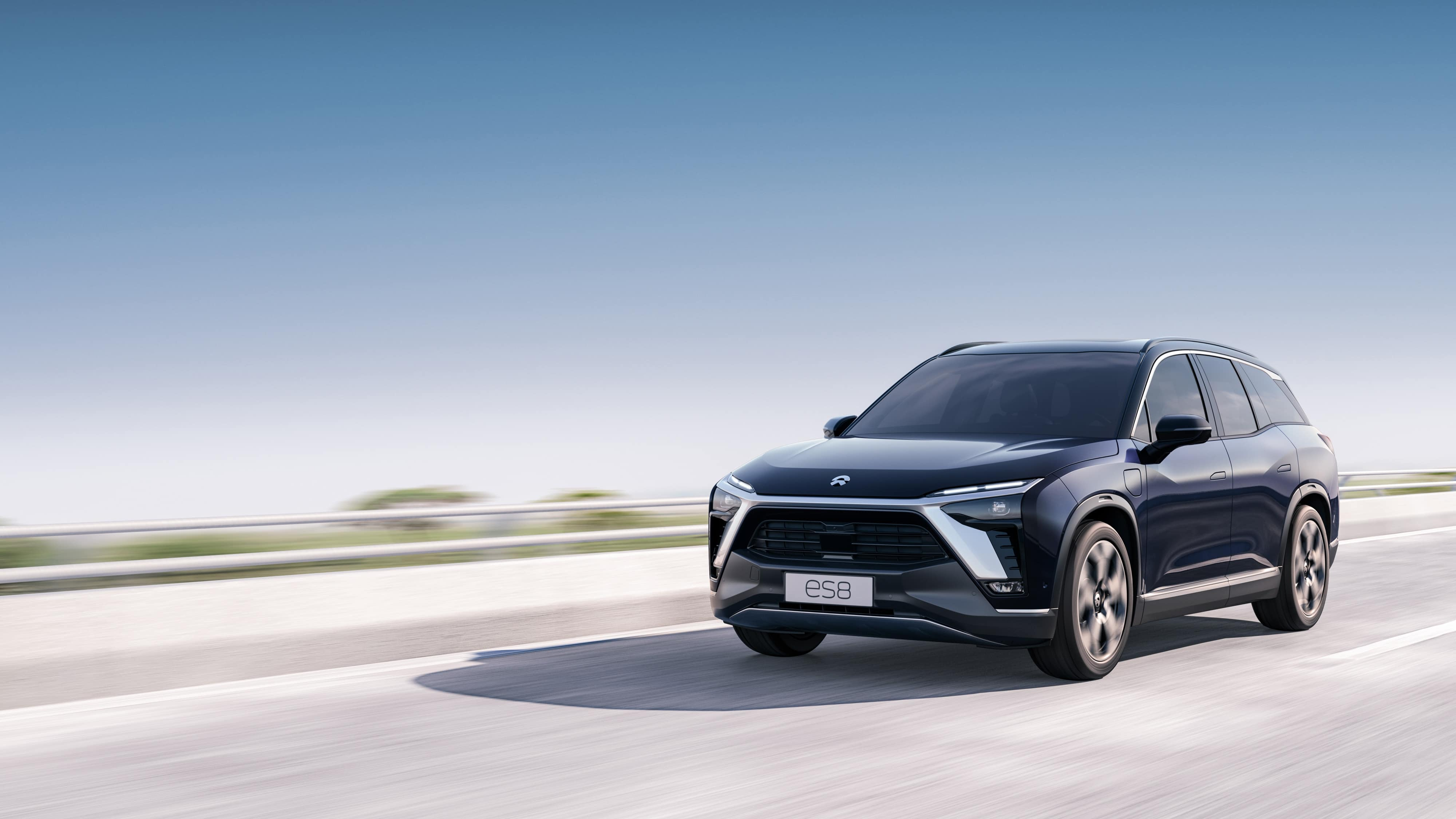 Black Nio ES8 electric SUV on road.