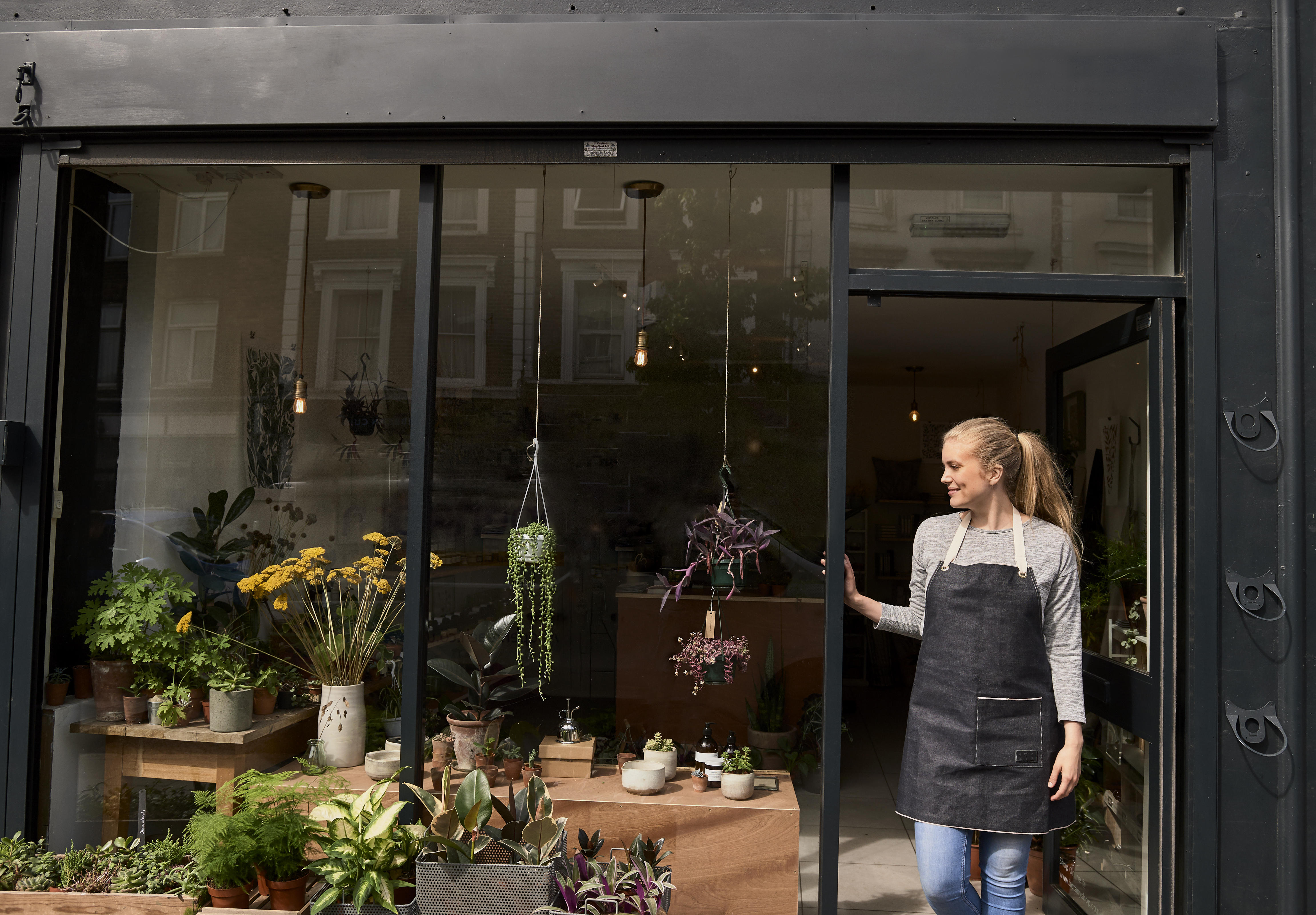 The owner of a florist business opening up the store in the morning.