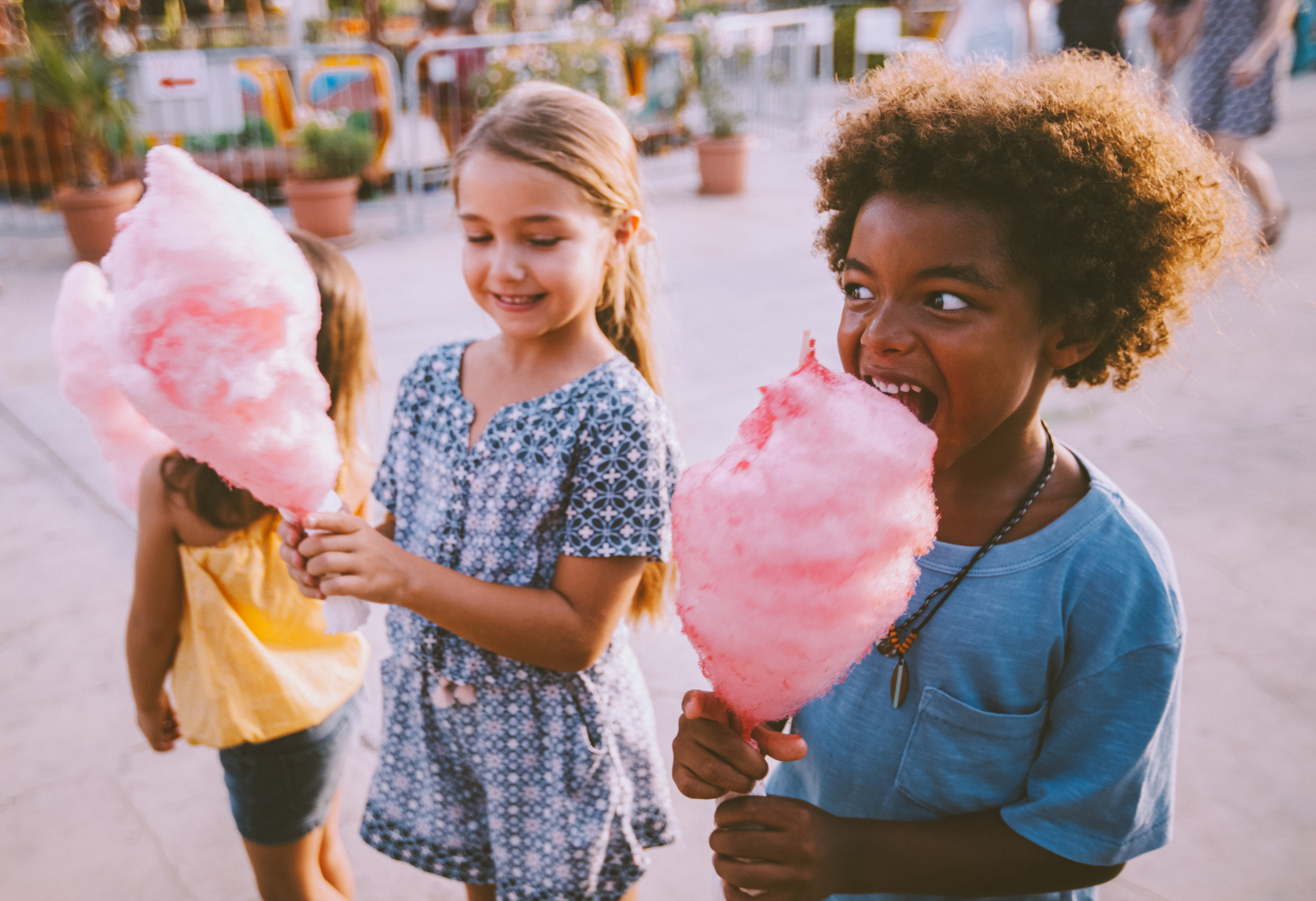 Children eating cotton candy.