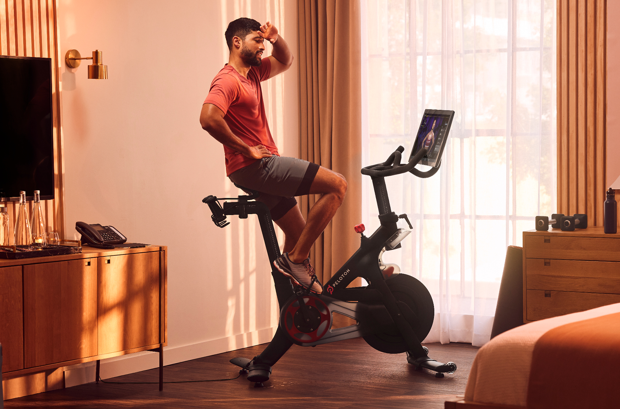 Person using Peloton Bike in a hotel room.