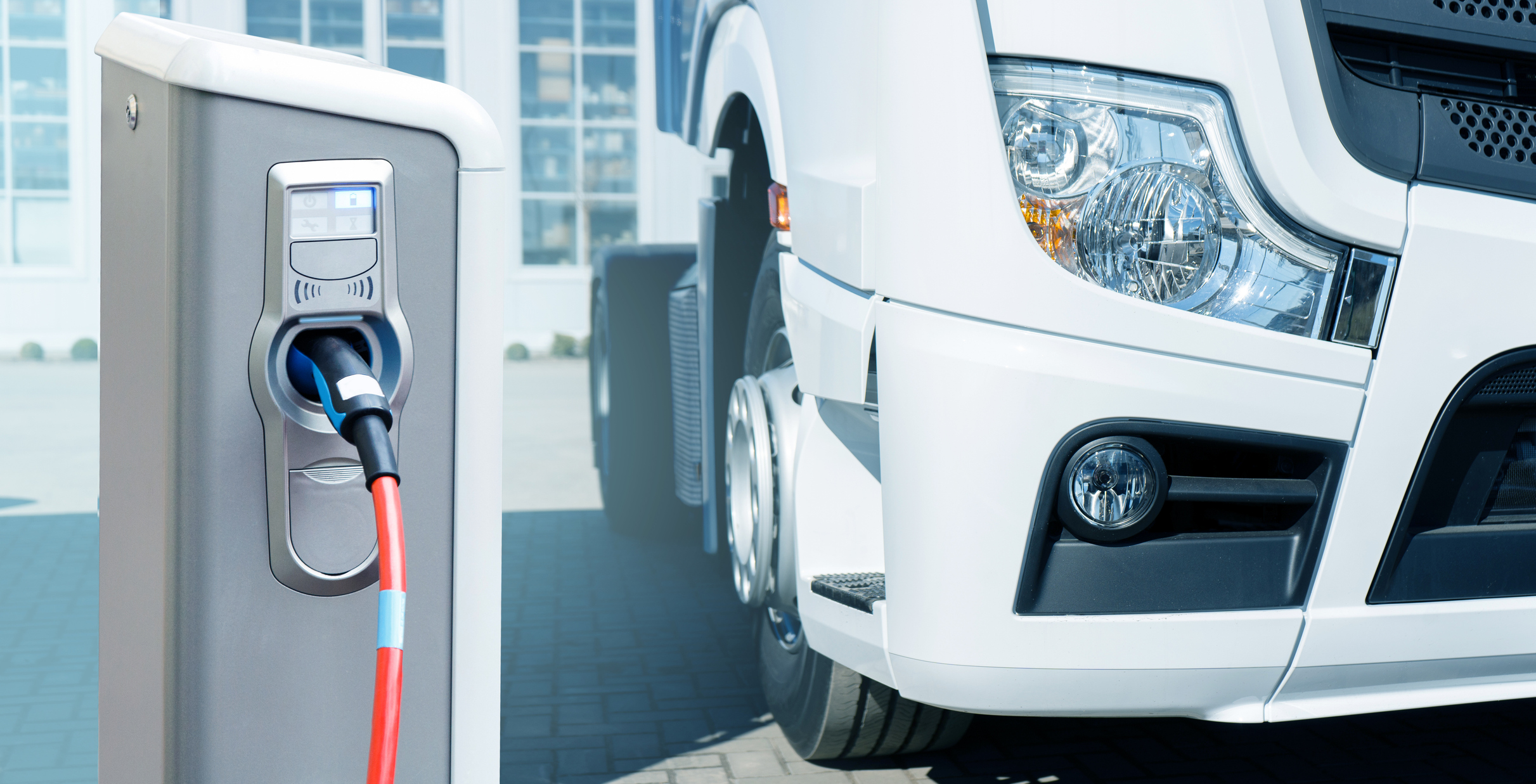 An electric truck at a charging station.