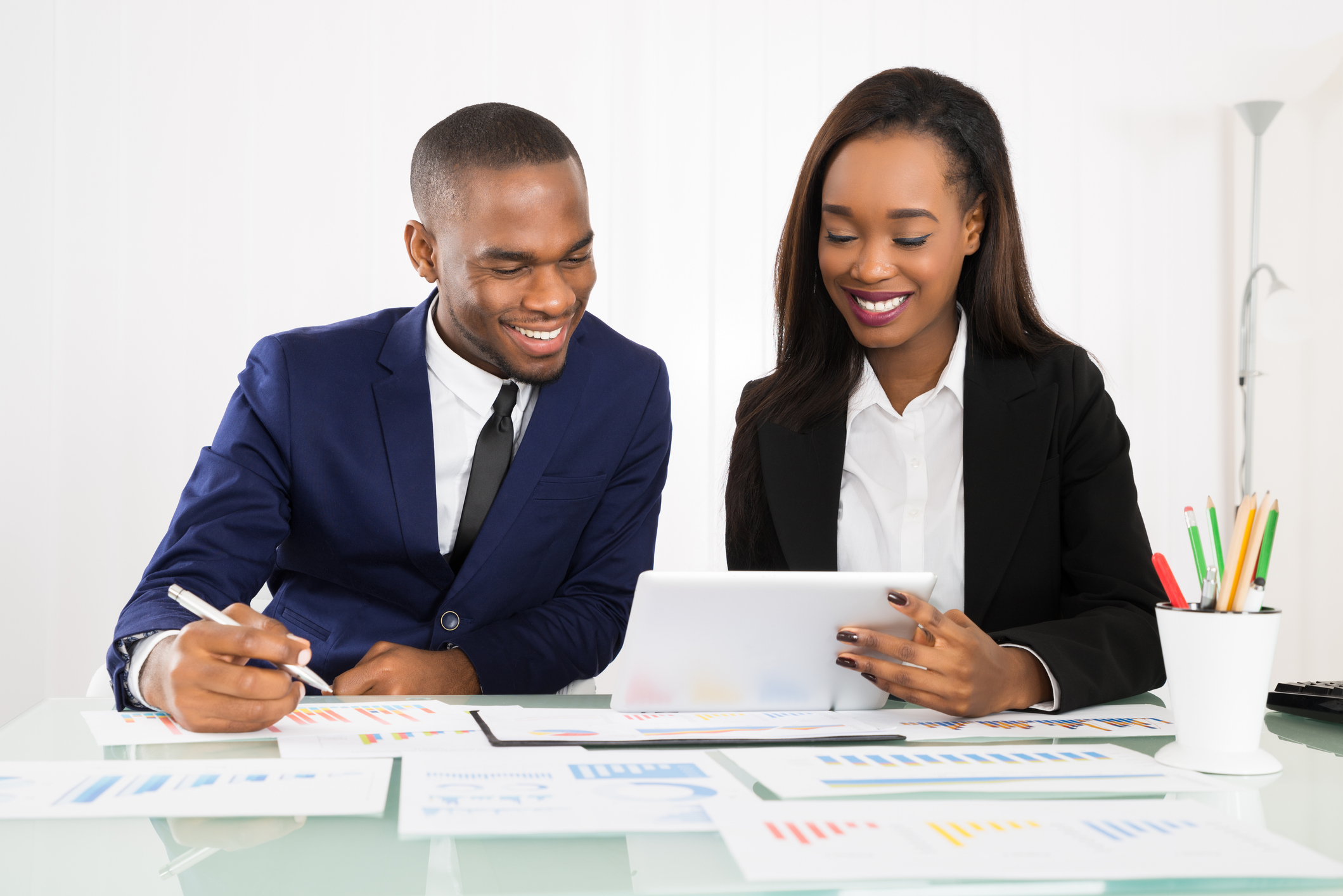 Two businesspeople looking at a tablet.
