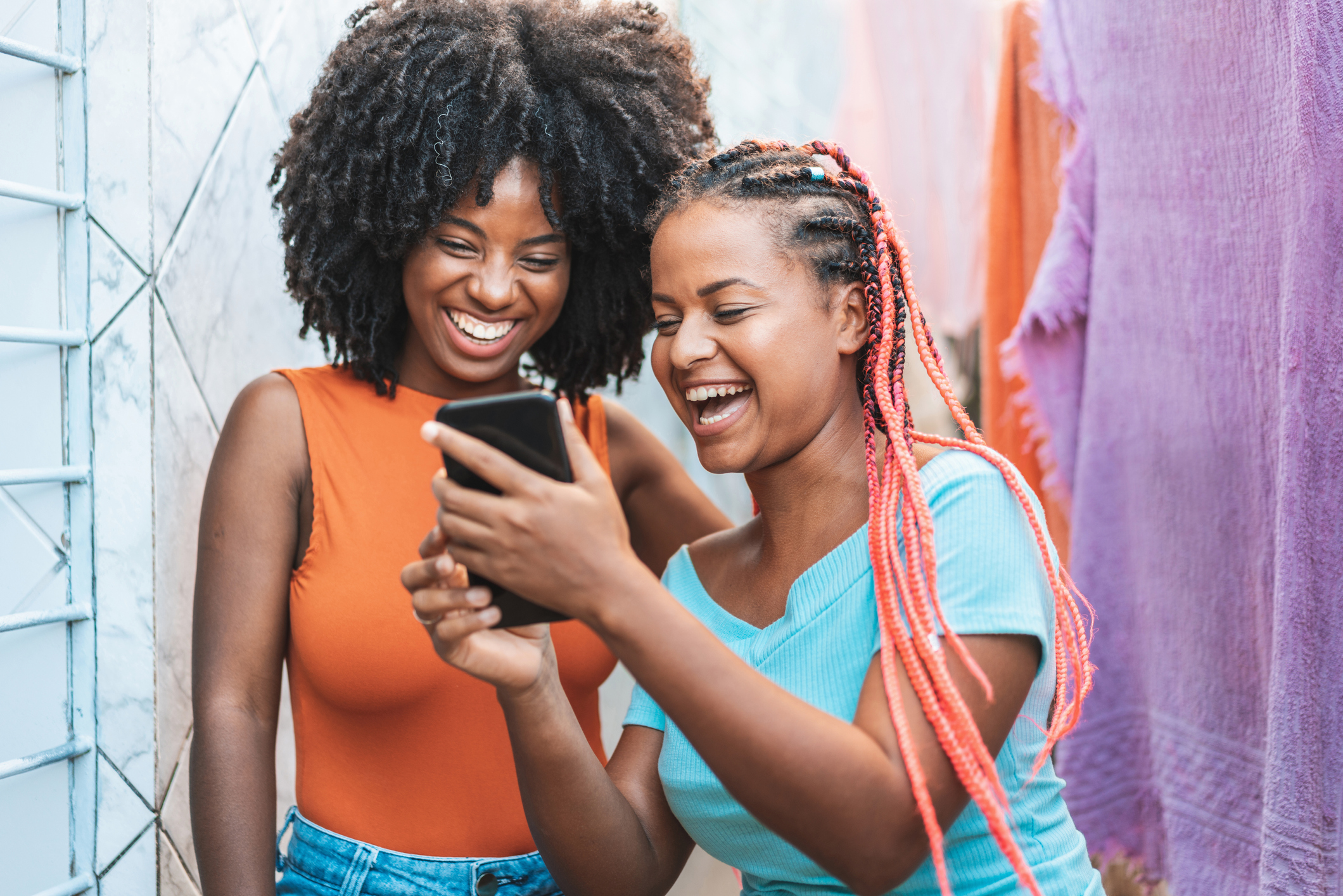 Two people looking at a phone.