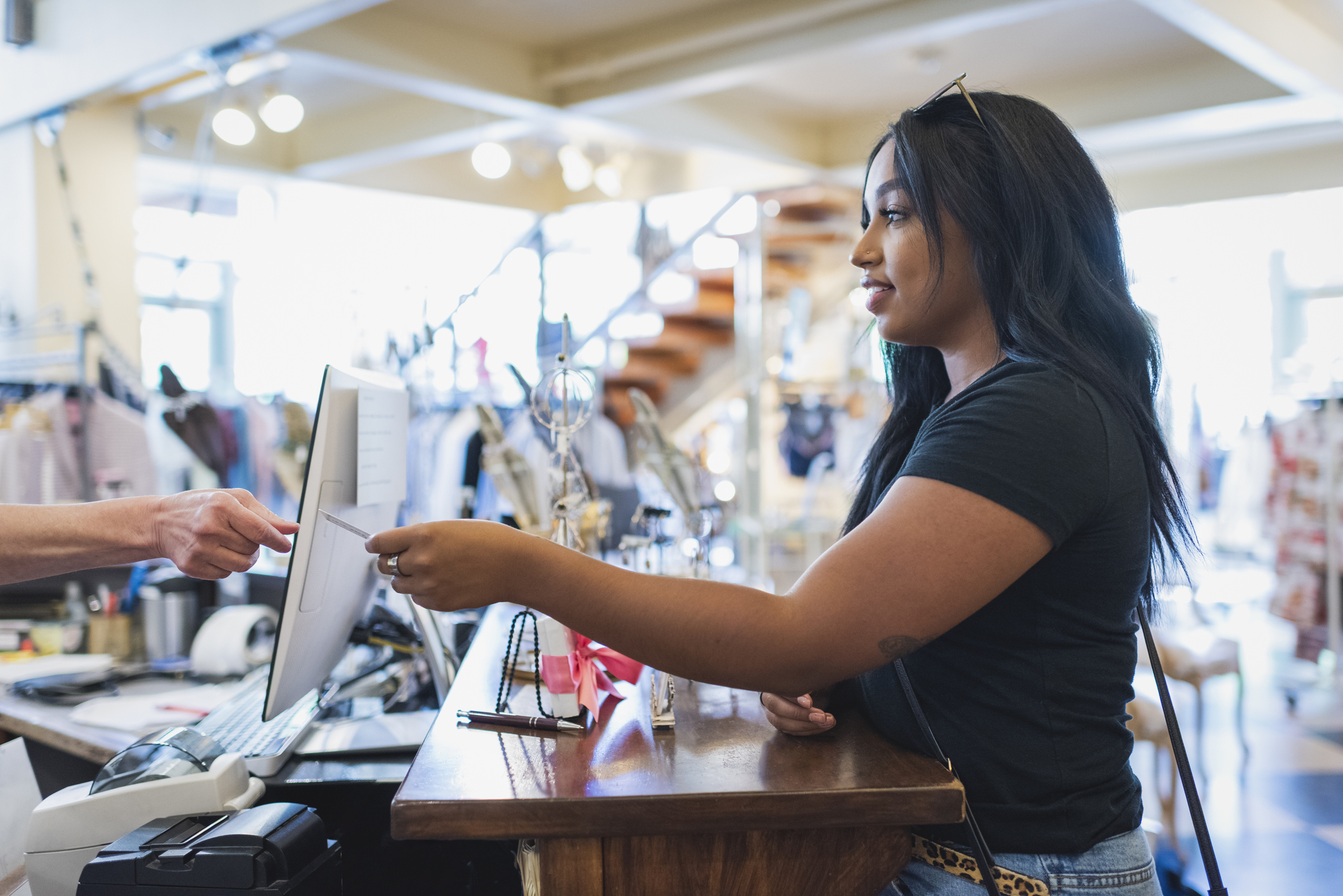 A person paying with a card in a store.