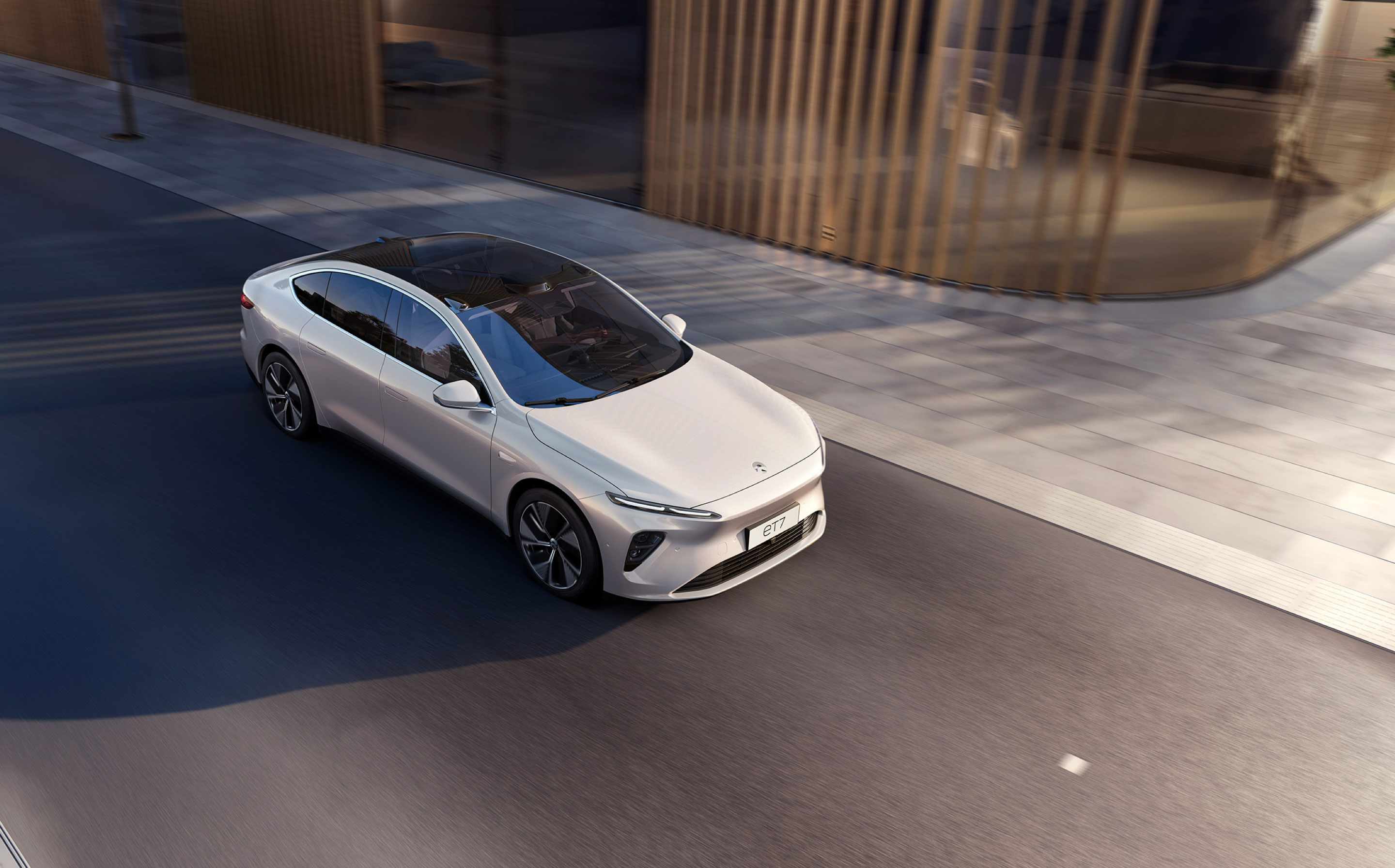 overhead view of Nio ET7 luxury sedan on city street.