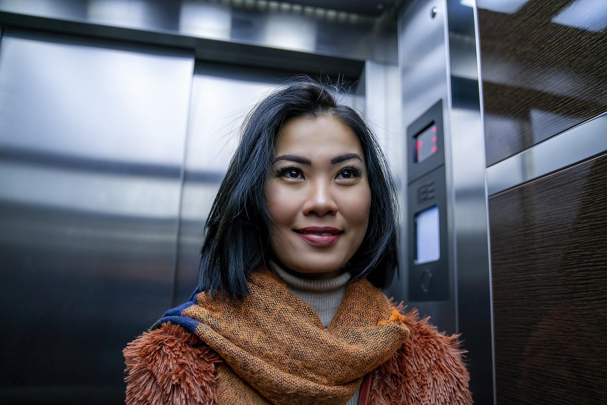 Person riding on an elevator.