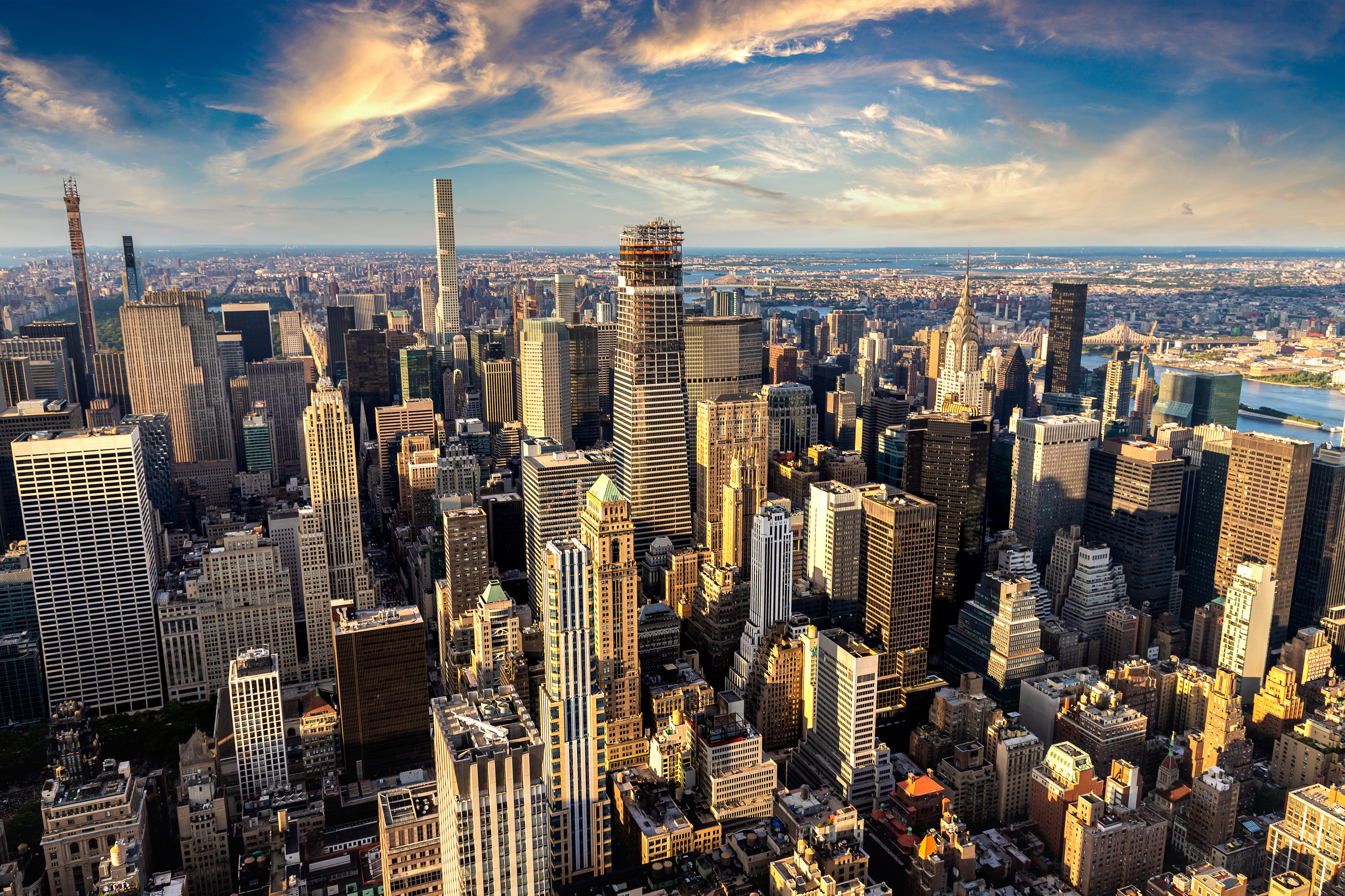 New York City skyline with clouds above.