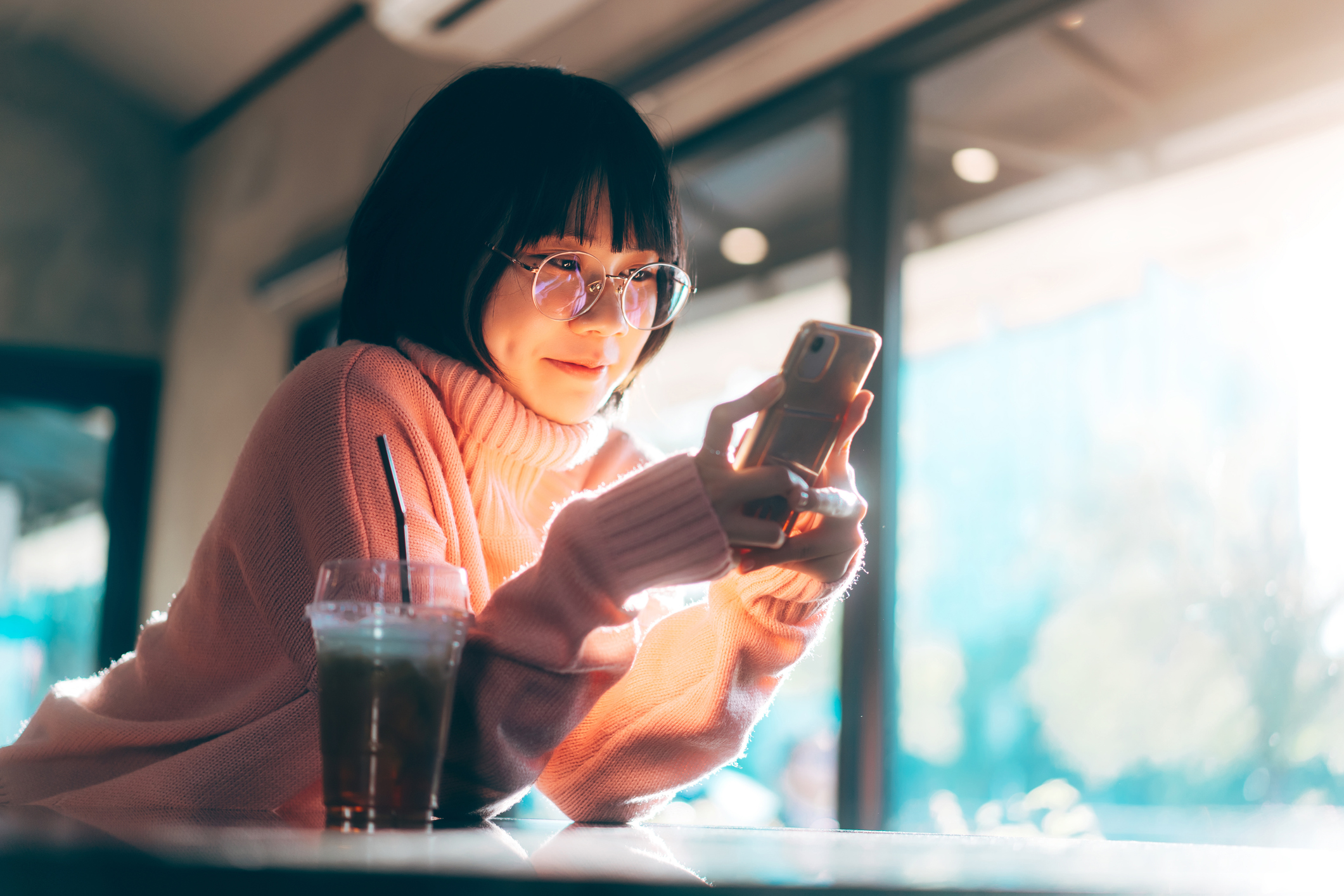 A woman looking at a phone.