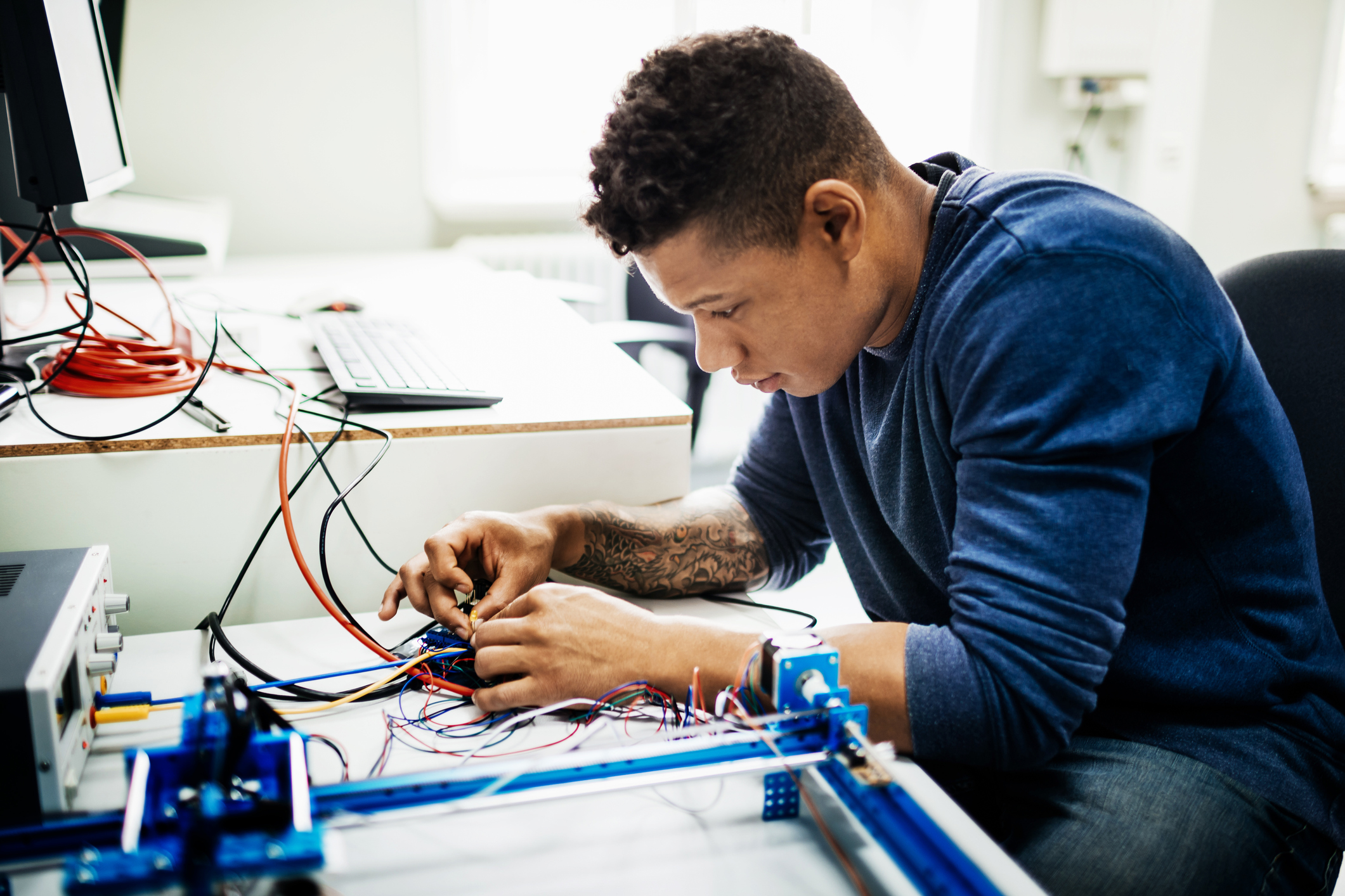 A person working on an electric circuit.