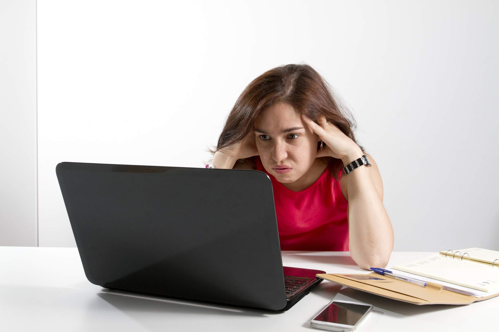 Person looking at their laptop frustrated.