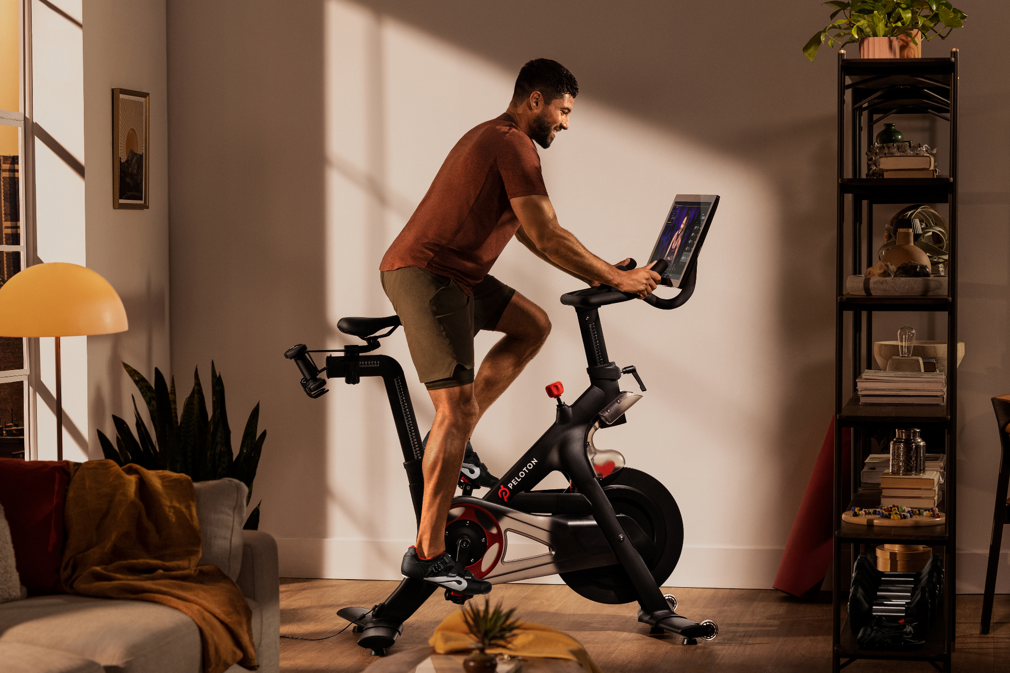 Person riding a Peloton Bike at home.