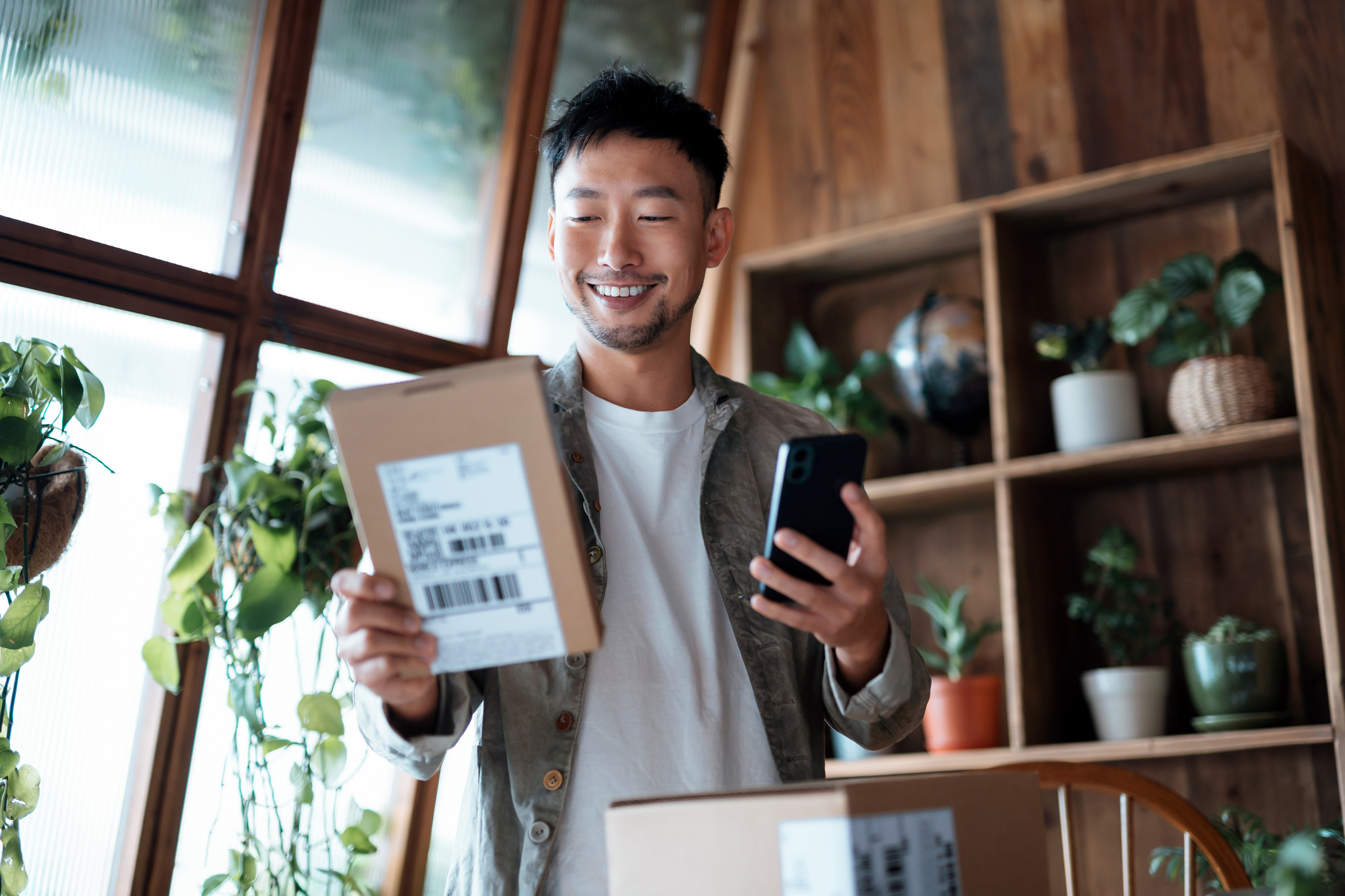 Customer smiling after receiving a package in the mail at their house.