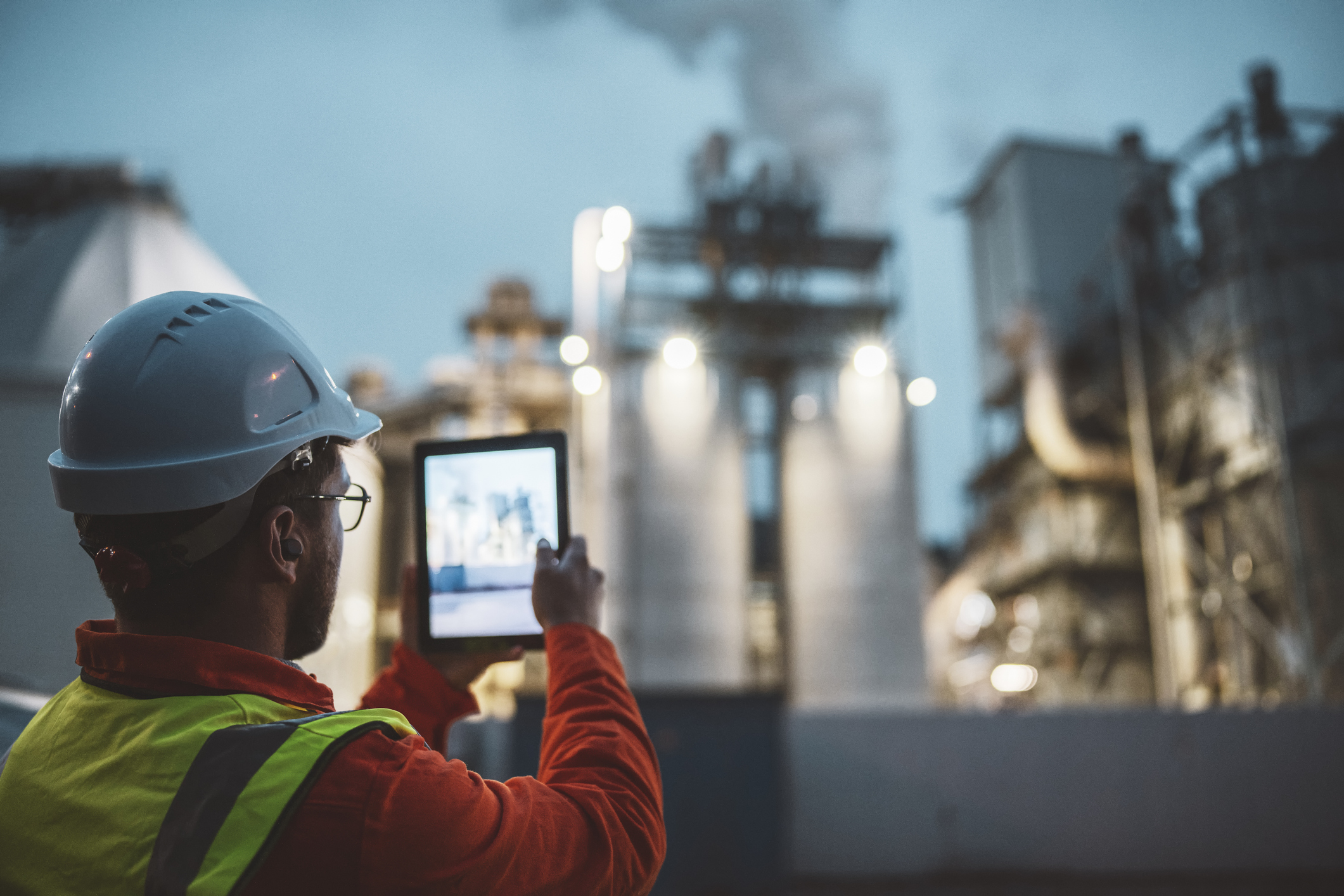 A worker monitors an oil rig.