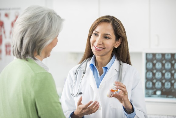 Doctor giving a patient medication.