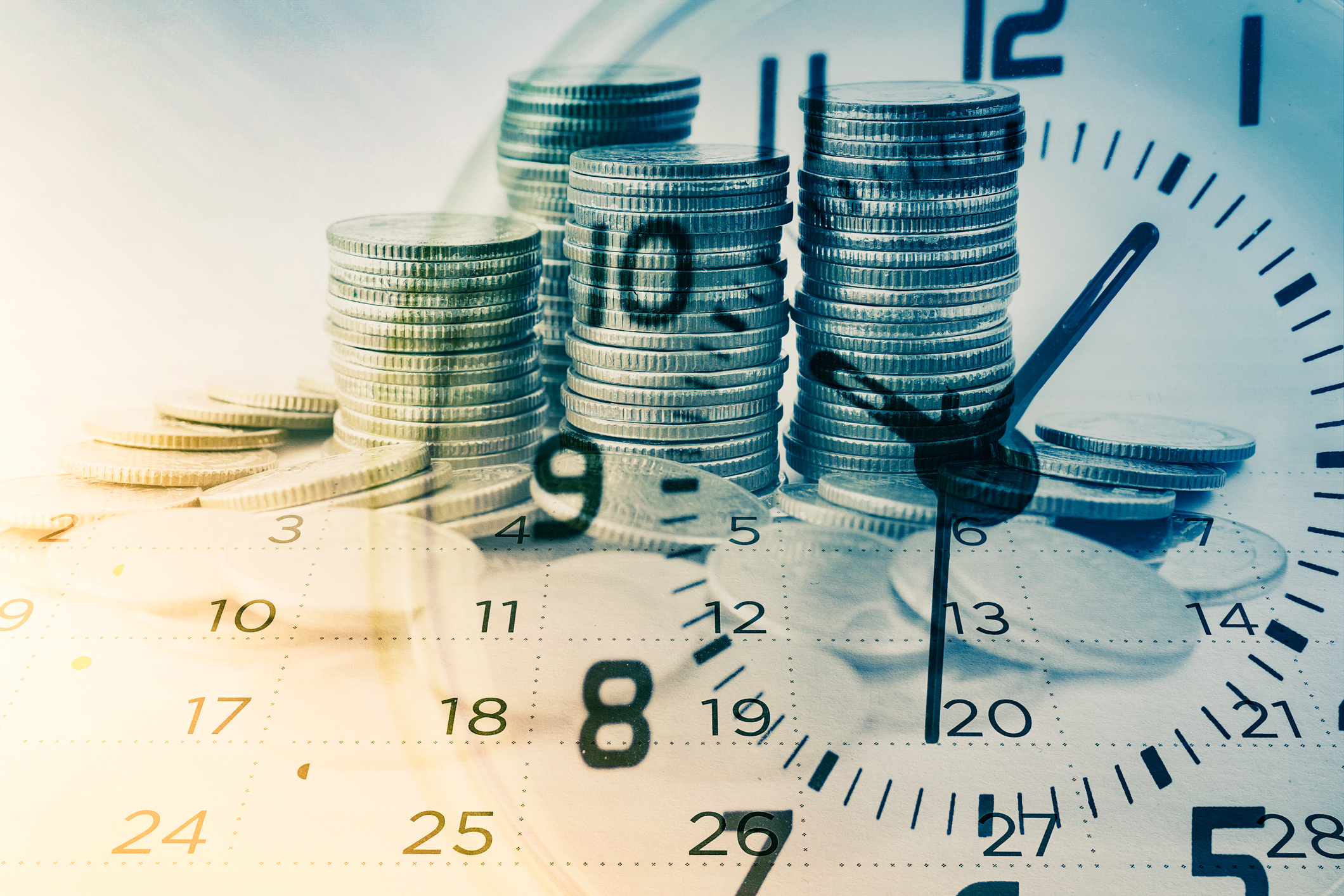 Coins piling up behind the face of a clock indicating dividends over time. 